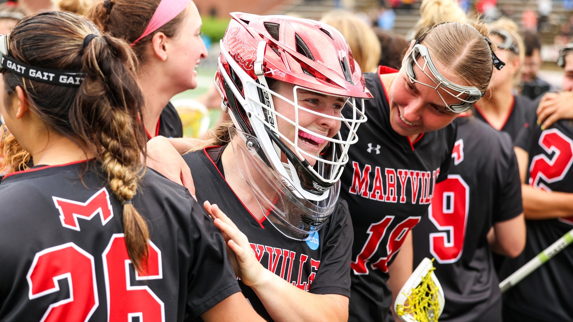 Gianna Guzek celebrates on the field with her teammates after advancing to the final four