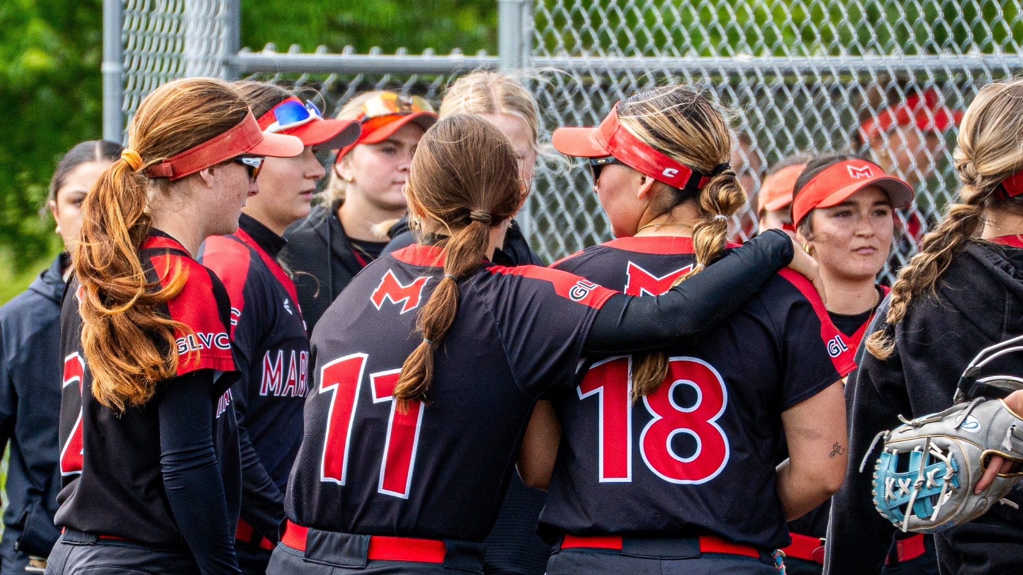 Softball Players Huddle Together