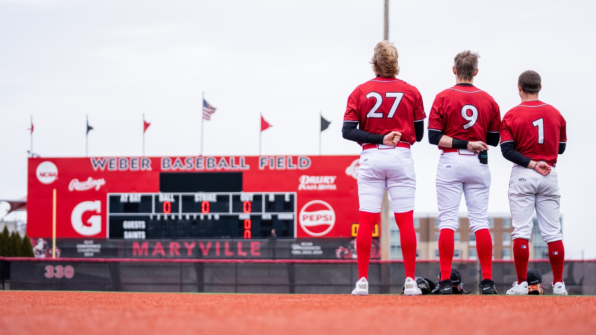 Baseball Players look to the flag during the national anthem