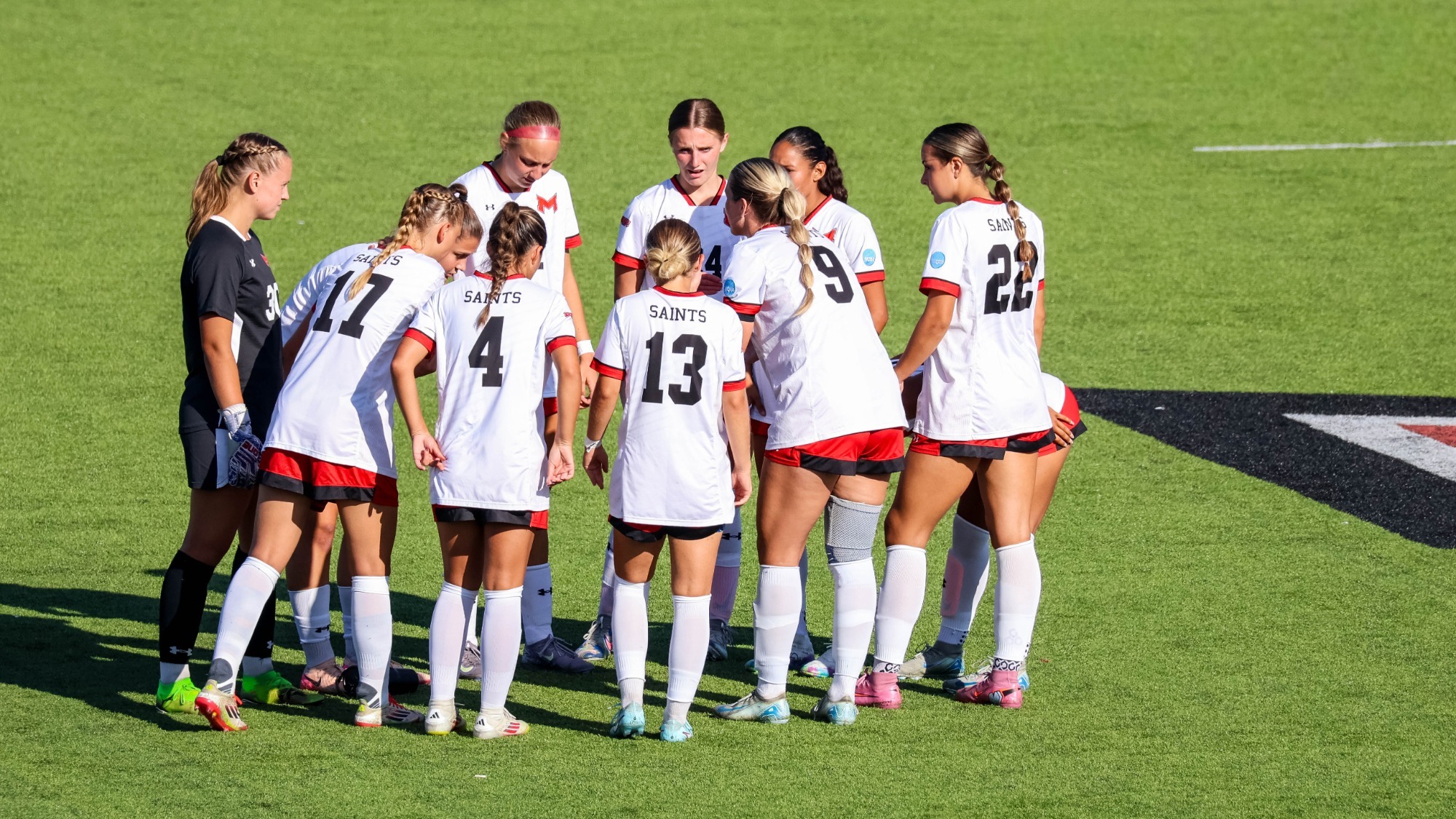 Women's Soccer huddles up before a game at Lonnie Folks Field