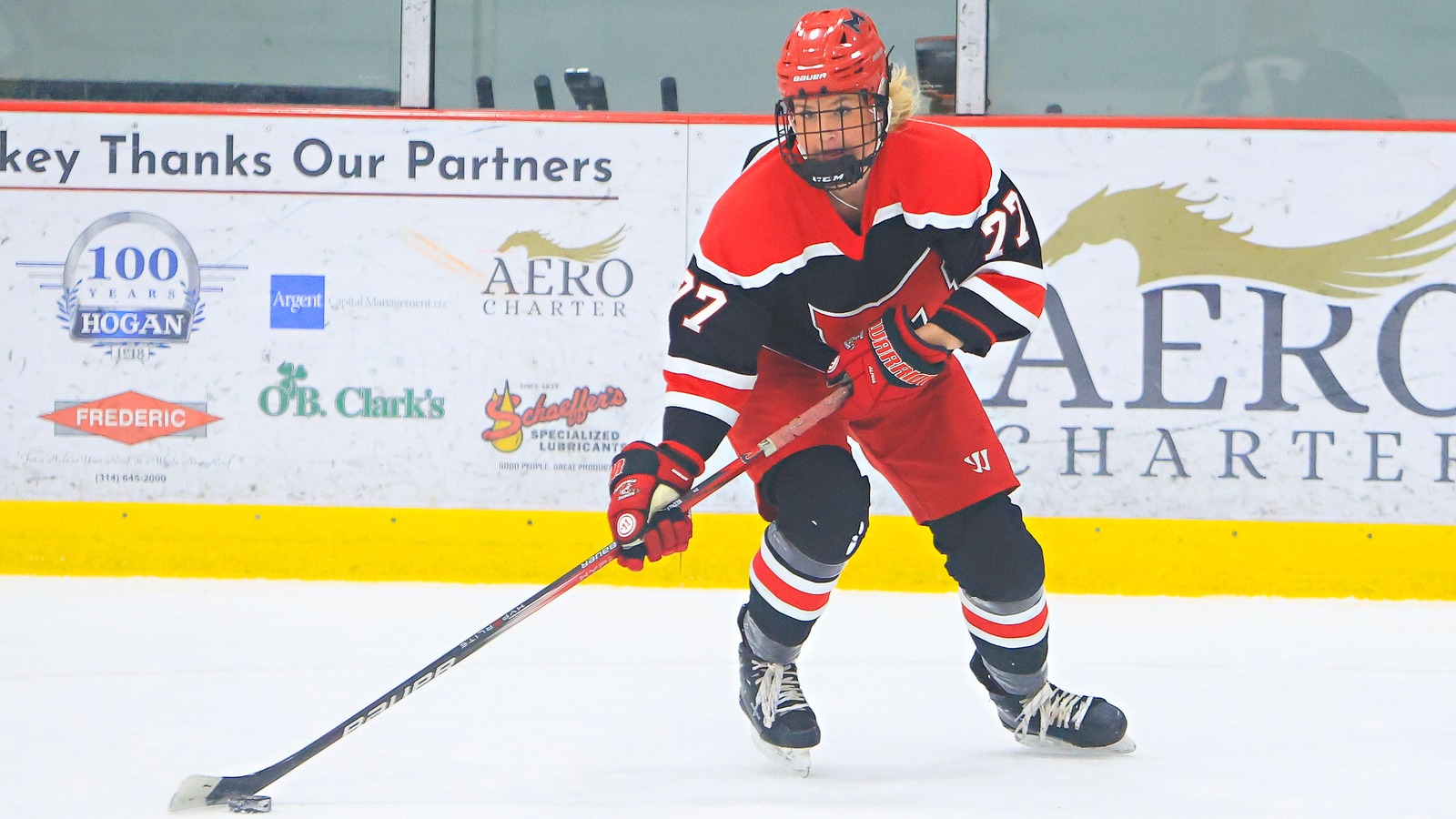 Women's Ice Hockey player moves the puck