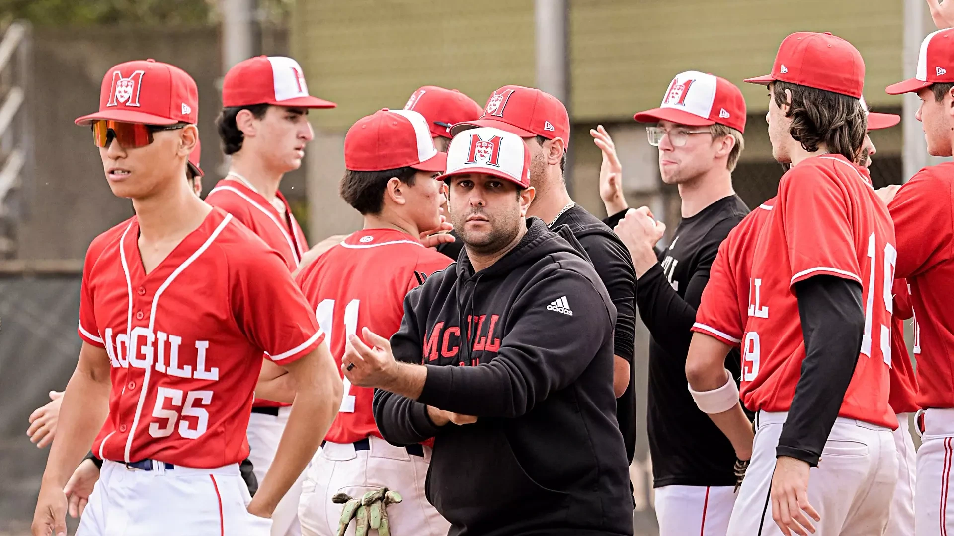 McGill baseball head coach Chris Haddad in middle of post-game celebration