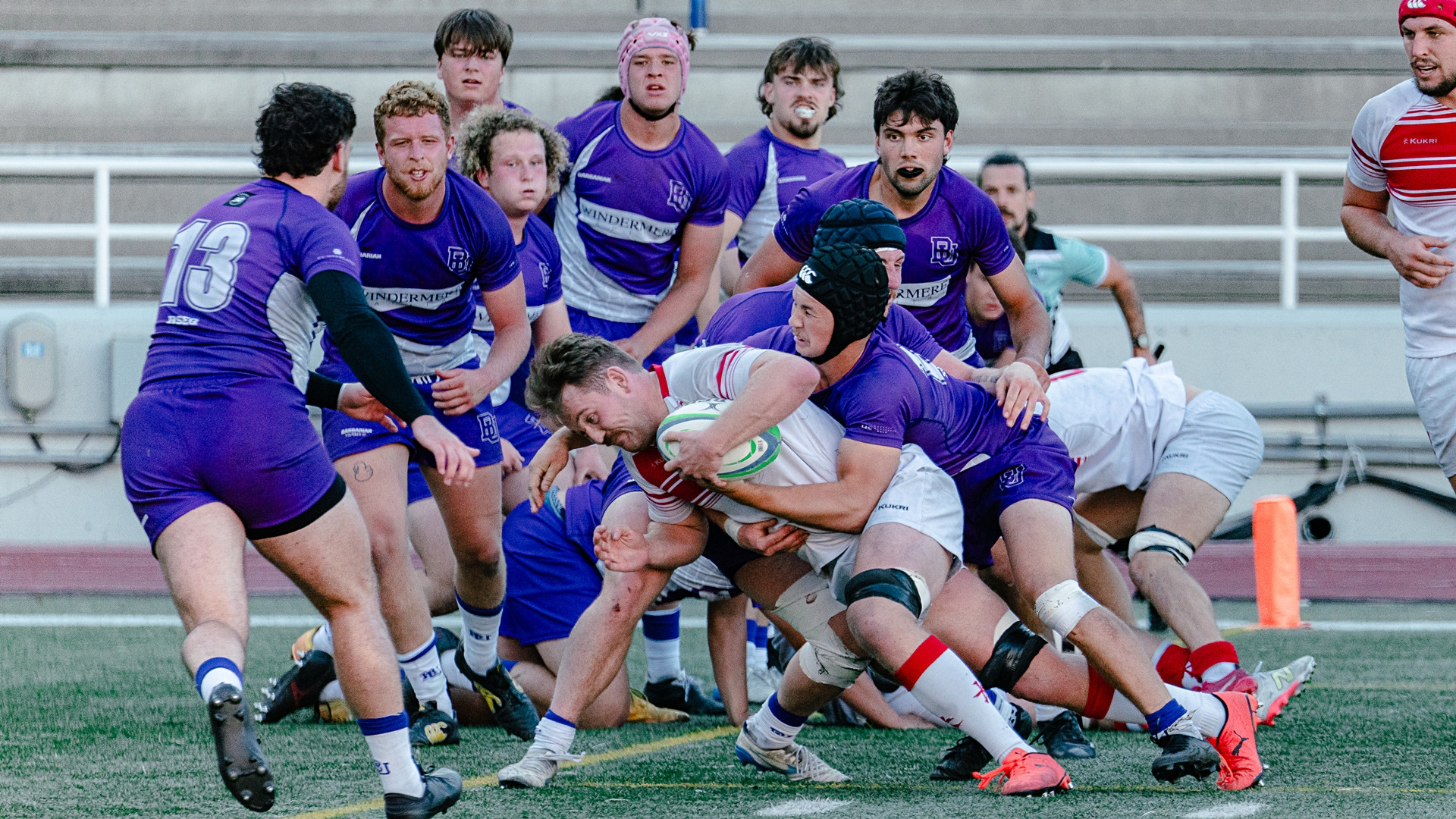 Redbirds rugby player nears endzone against a gaggle of Gaiters