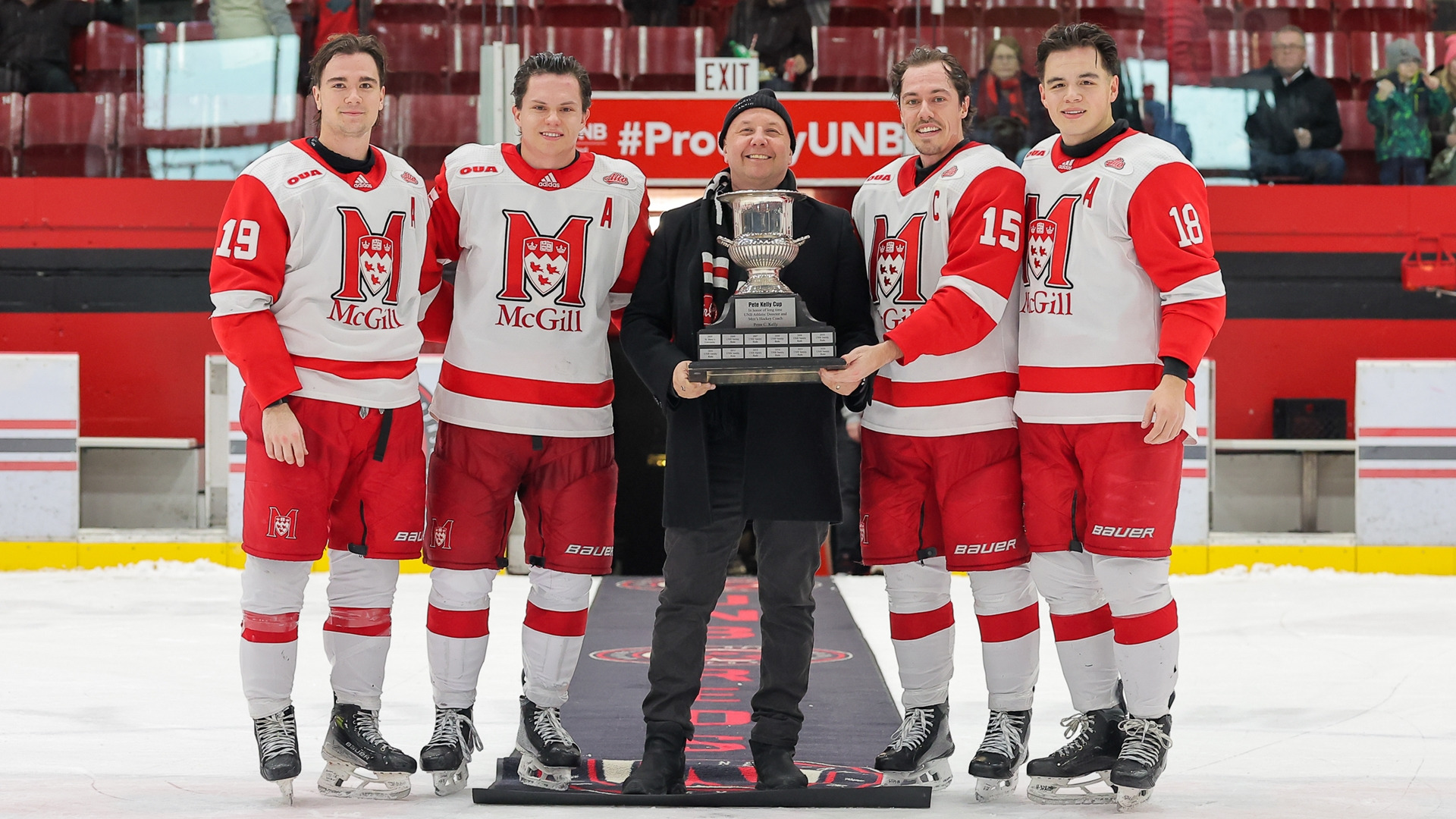 McGill captains (L to R) William Rouleau, Mathieu Gagnon, Alex Gagnon and Mikisiw Awashish receive Pete Kelly Cup from Craig Allen of Peterbilt Atlantic