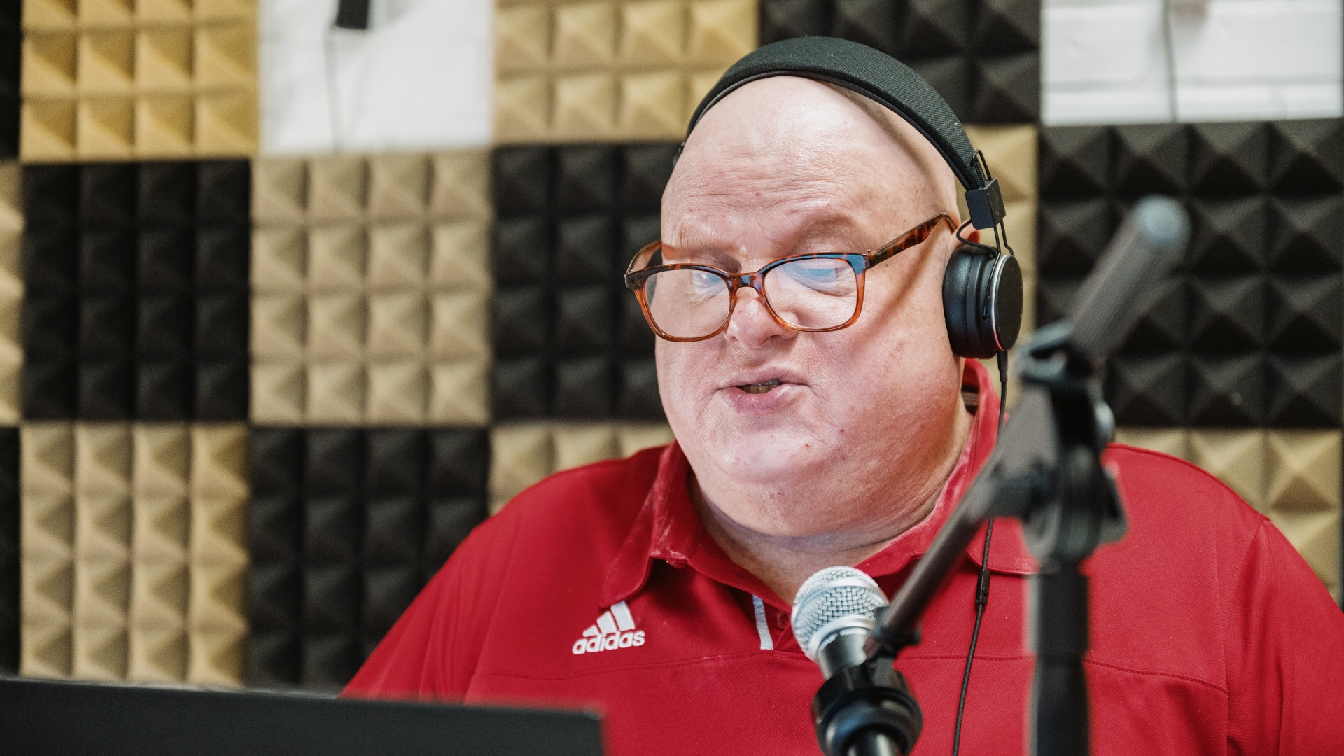 Sports information officer Earl Zukerman recording a 2021 episode of his Alma Matters podcast