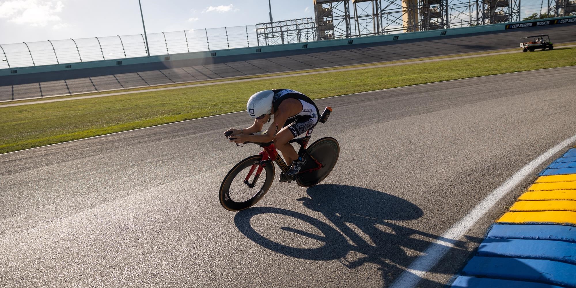 Taylor Reid, professional triathlete and former Marauder cross country runner, cycles around a track