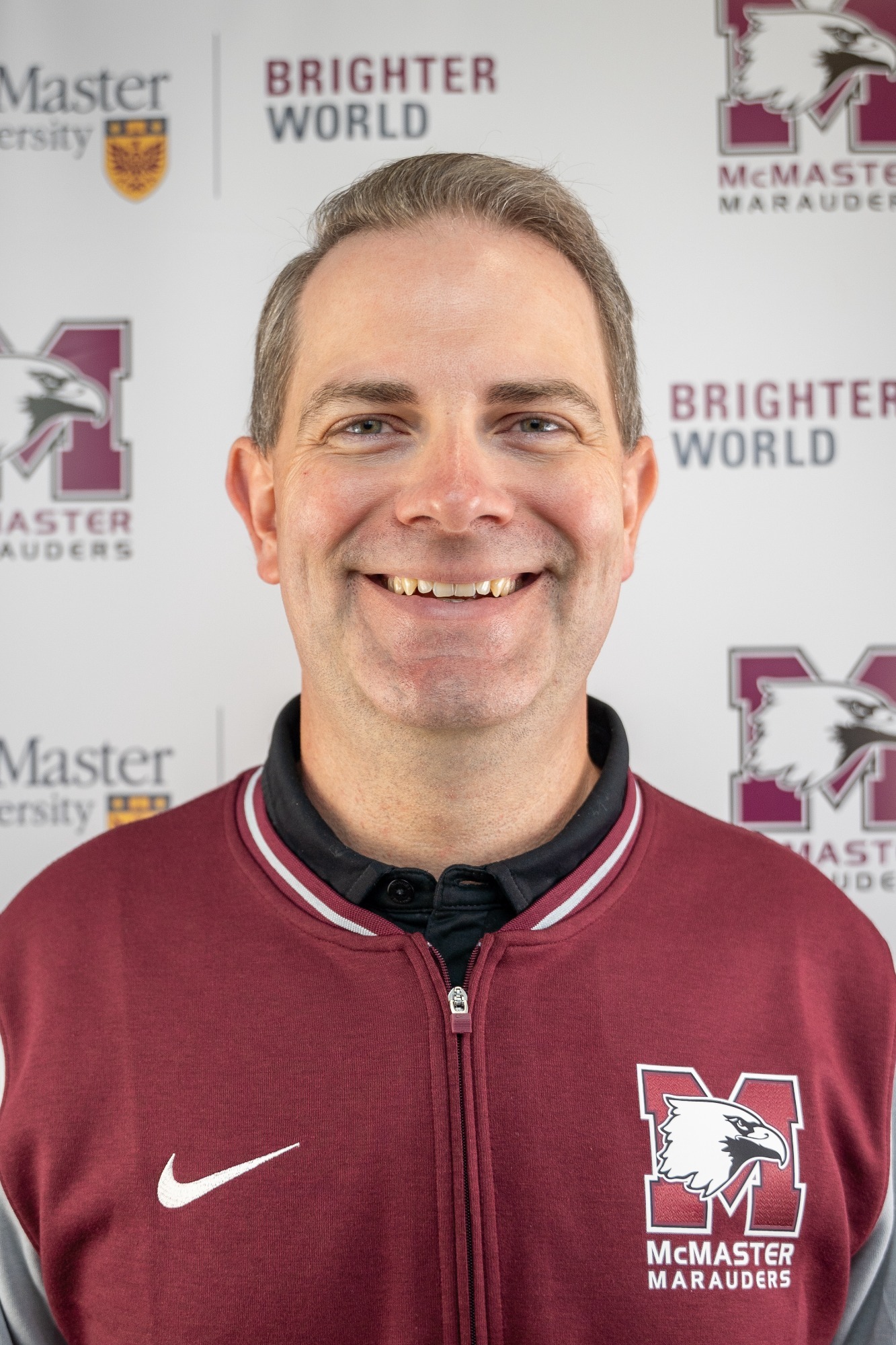 A portrait photo of Ben McFaul in front of a McMaster Marauders backdrop.