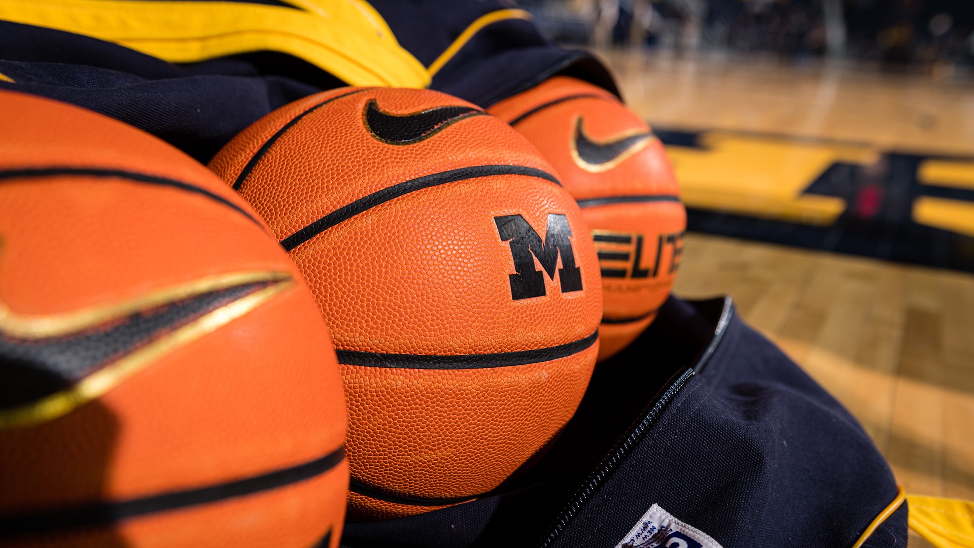 Michigan basketballs on the Crisler Center court