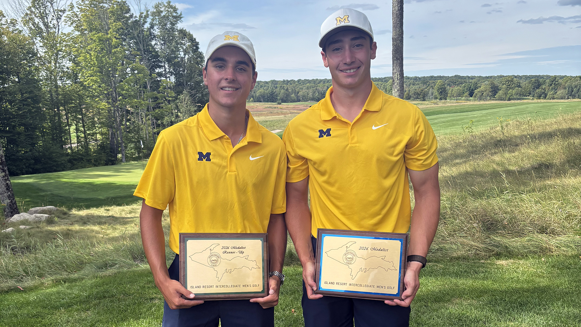 RJ Arone, left, and Spencer Shropshire pose with their trophies at the Island Resort Intercollegiate.