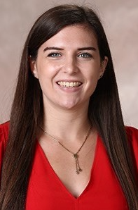 Headshot of Kelly Sorge in front of a beige background