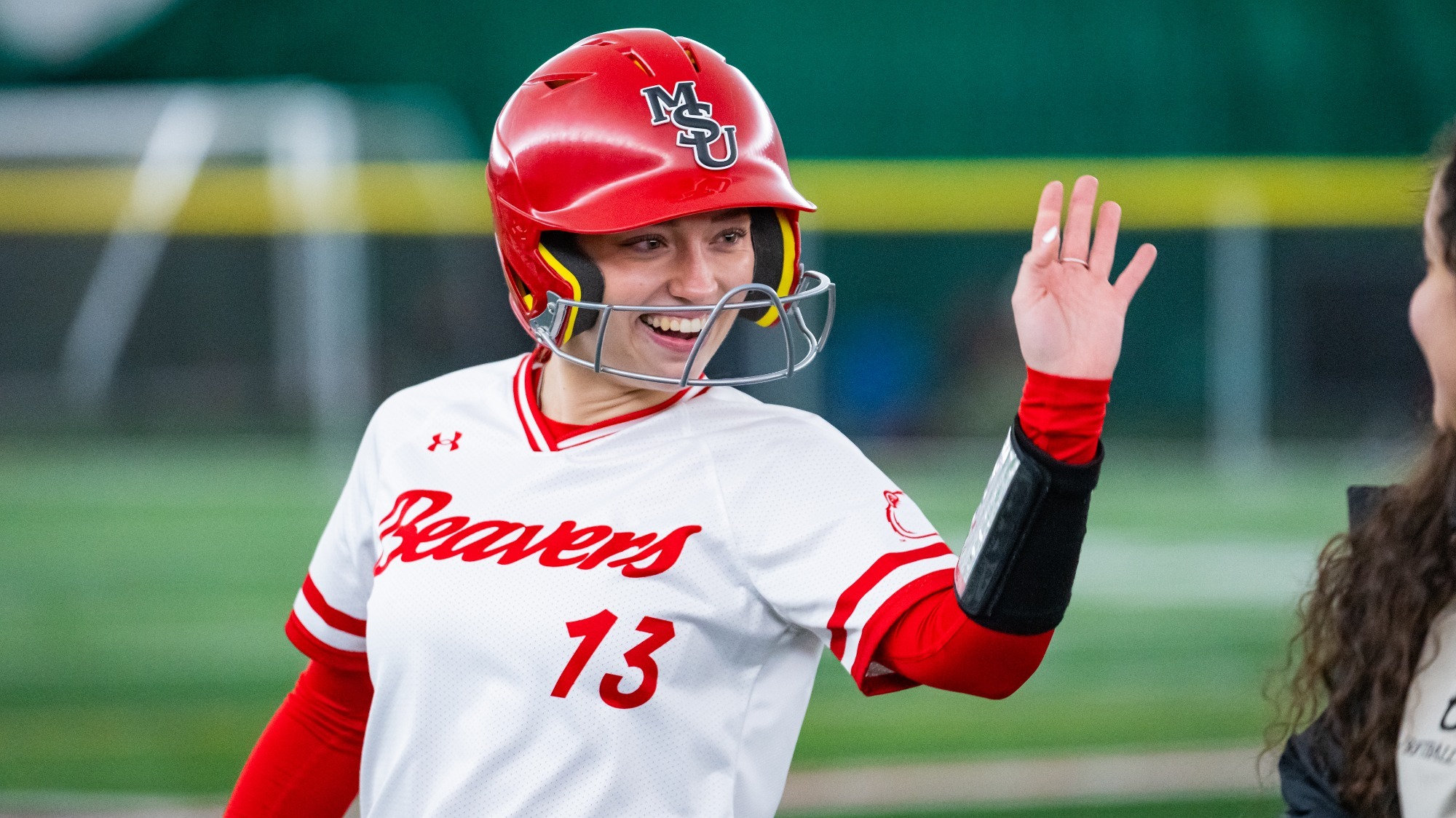 Jessie Henry celebrates hit against MSU Billings