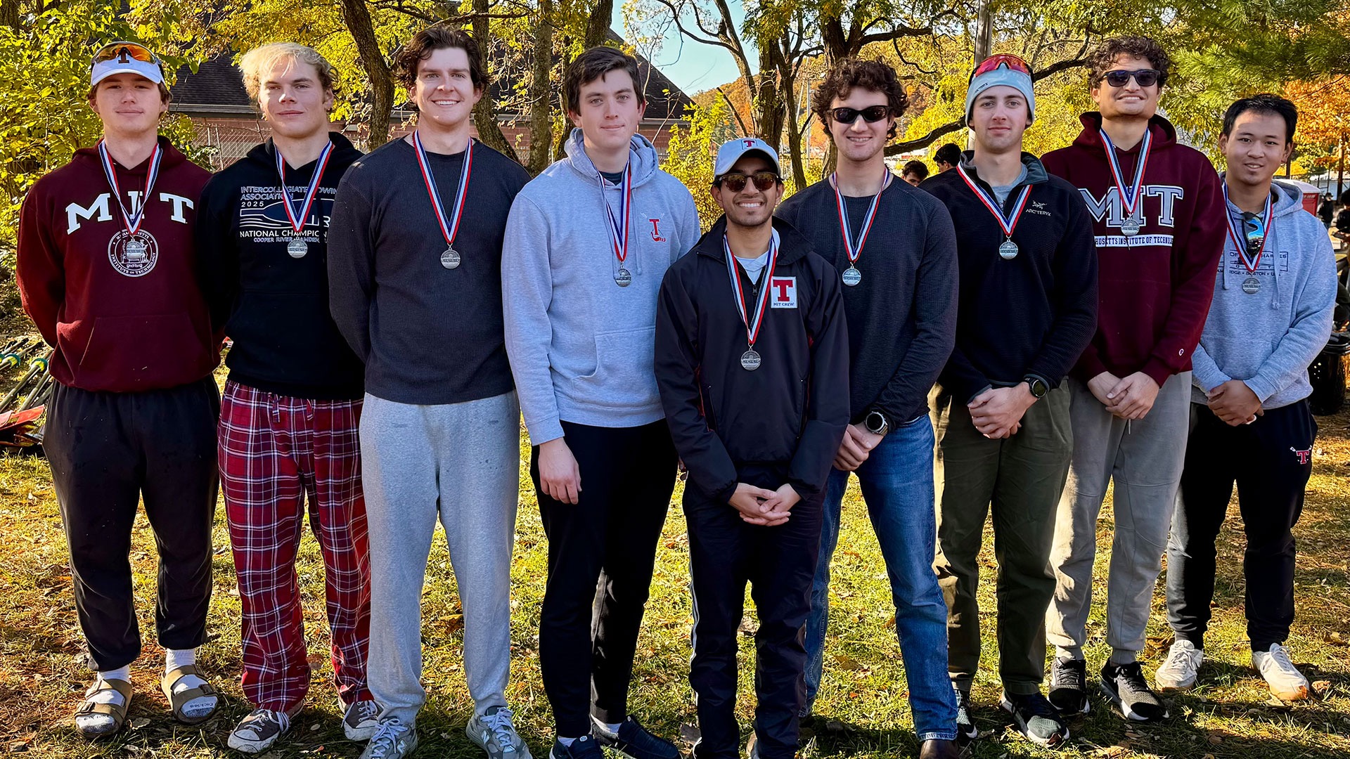 Men's Heavyweight crew varsity eight with silver medals following a race