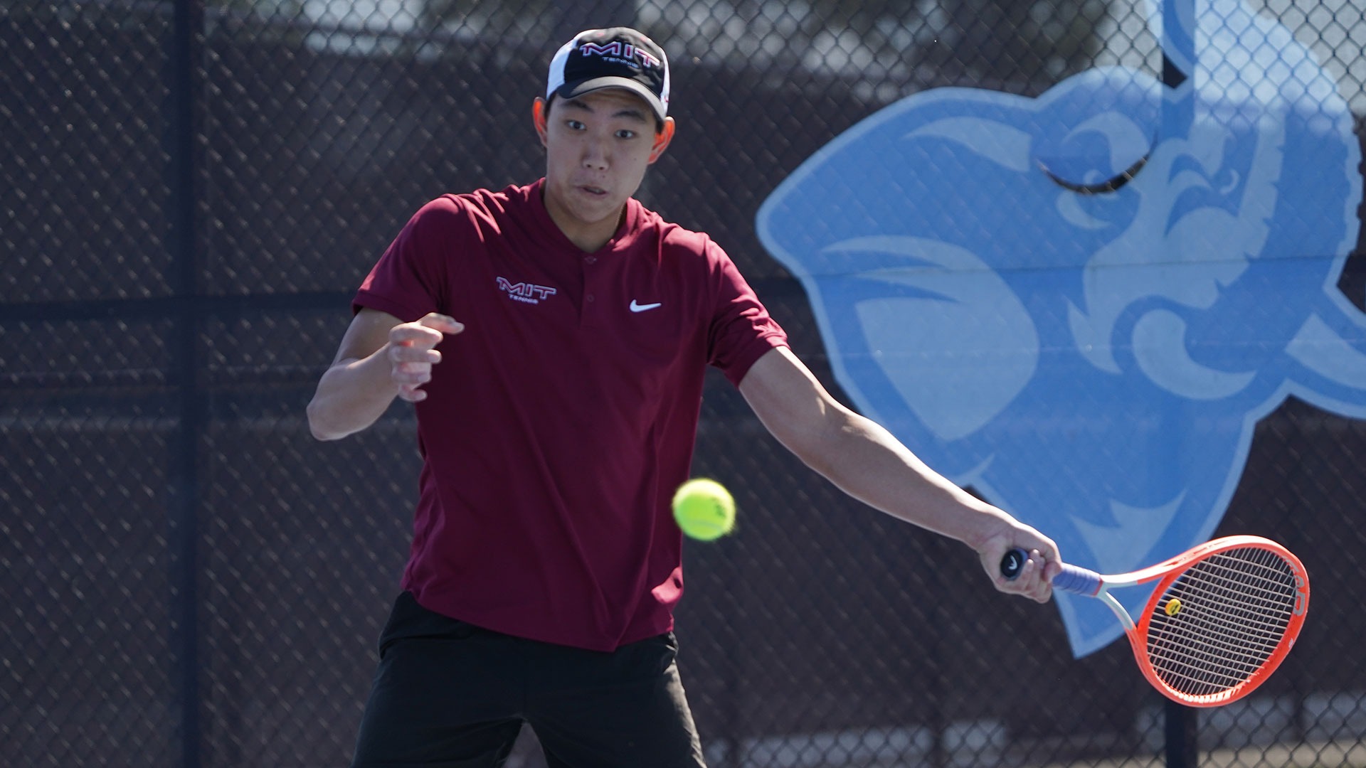 MIT men's tennis player hitting a forehand shot