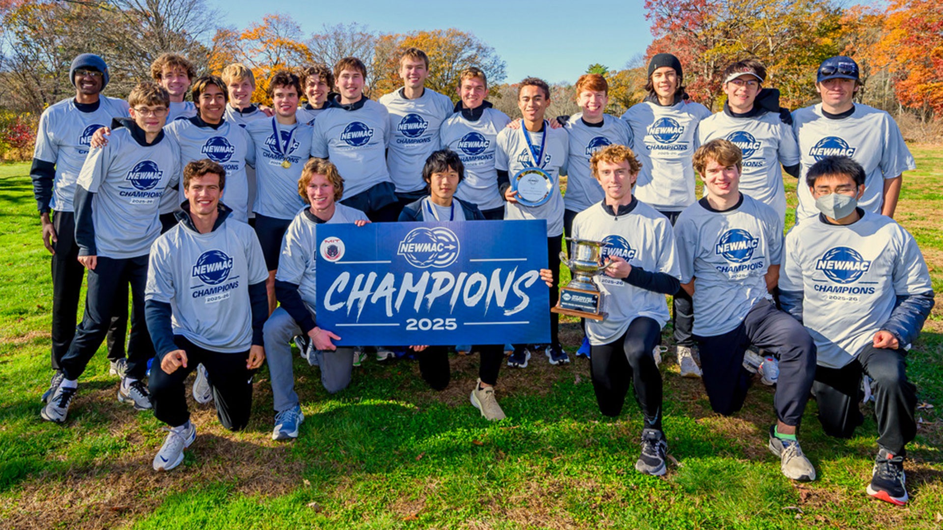 MIT men's cross country 2025 NEWMAC champions with trophy