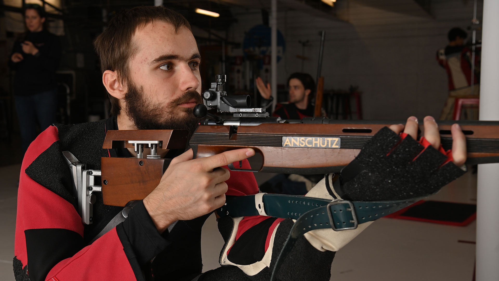 William Knowlton aiming his rifle down range