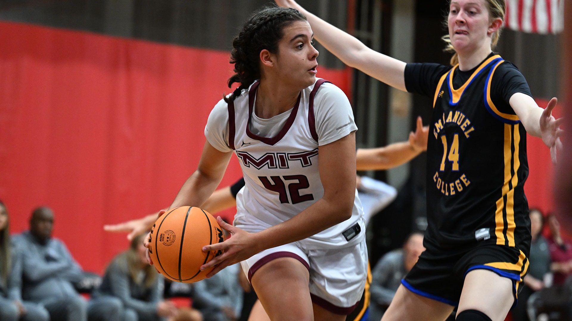 Mary Lobon holding the basketball while being defended