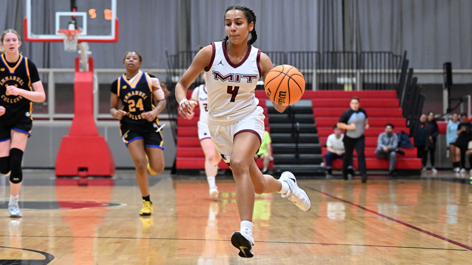 Ruth Lanouette dribbling a basketball while running down the court