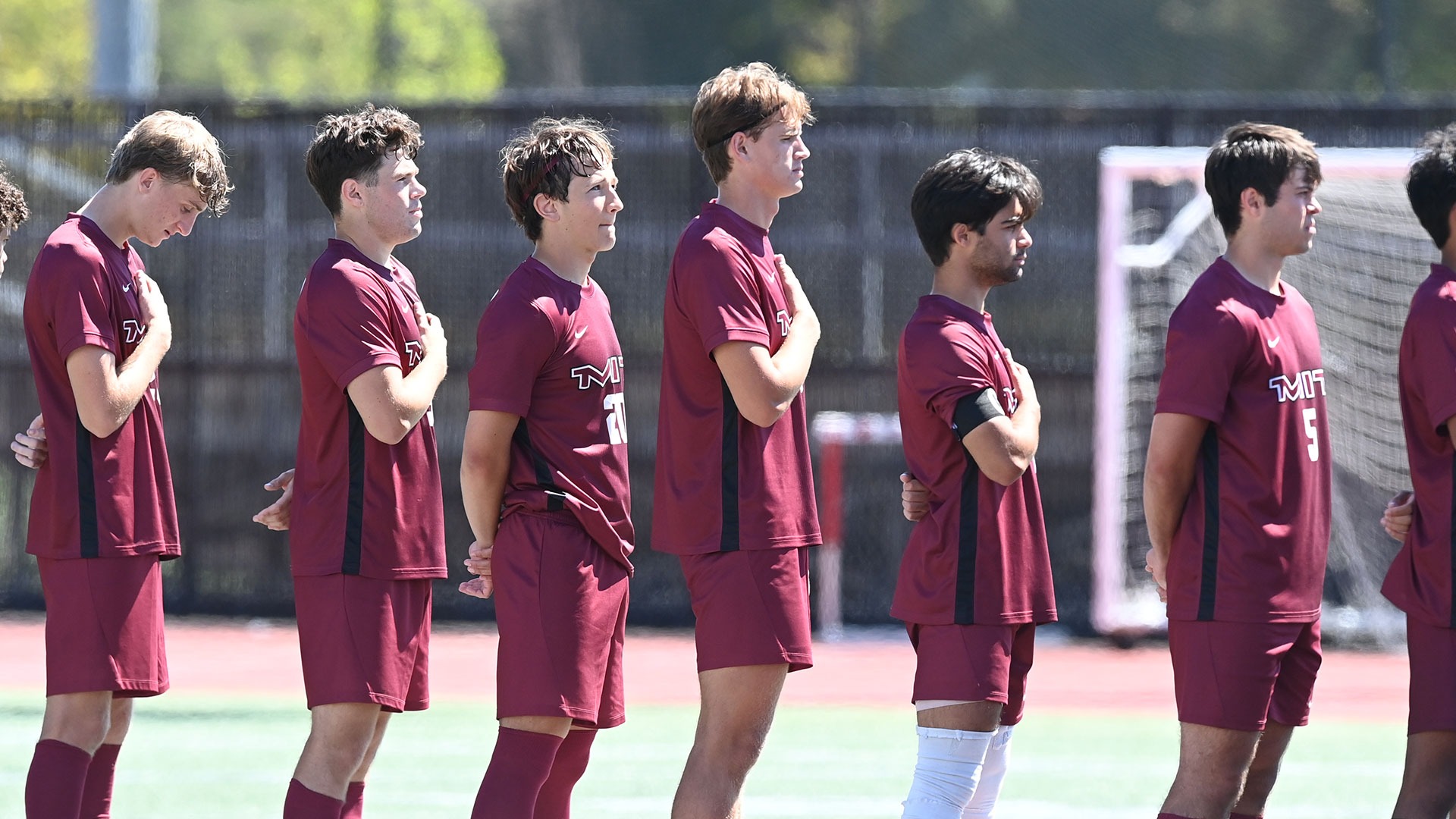 Members of the MIT men's soccer team lined up for the national anthem