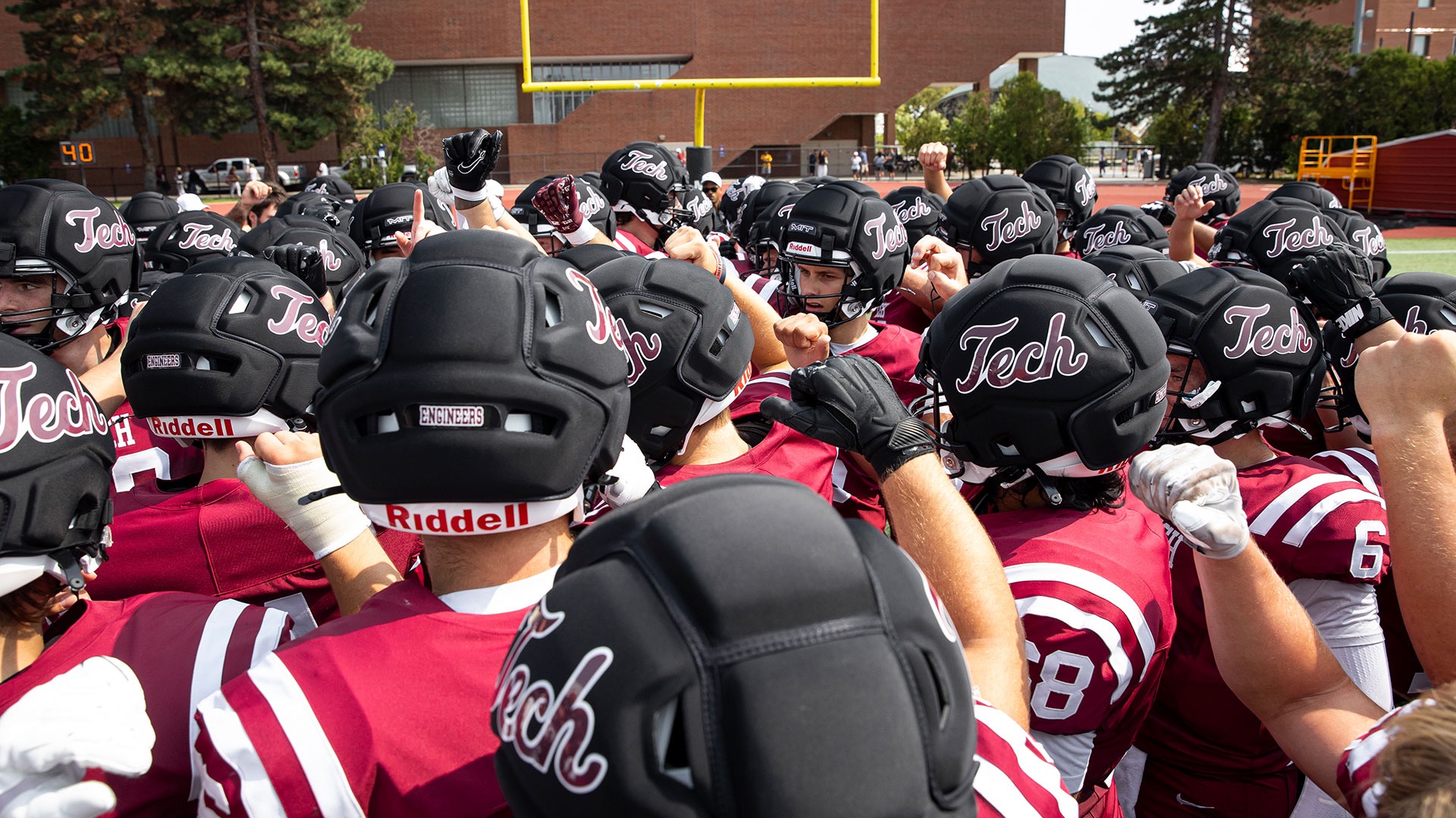 MIT football team huddle