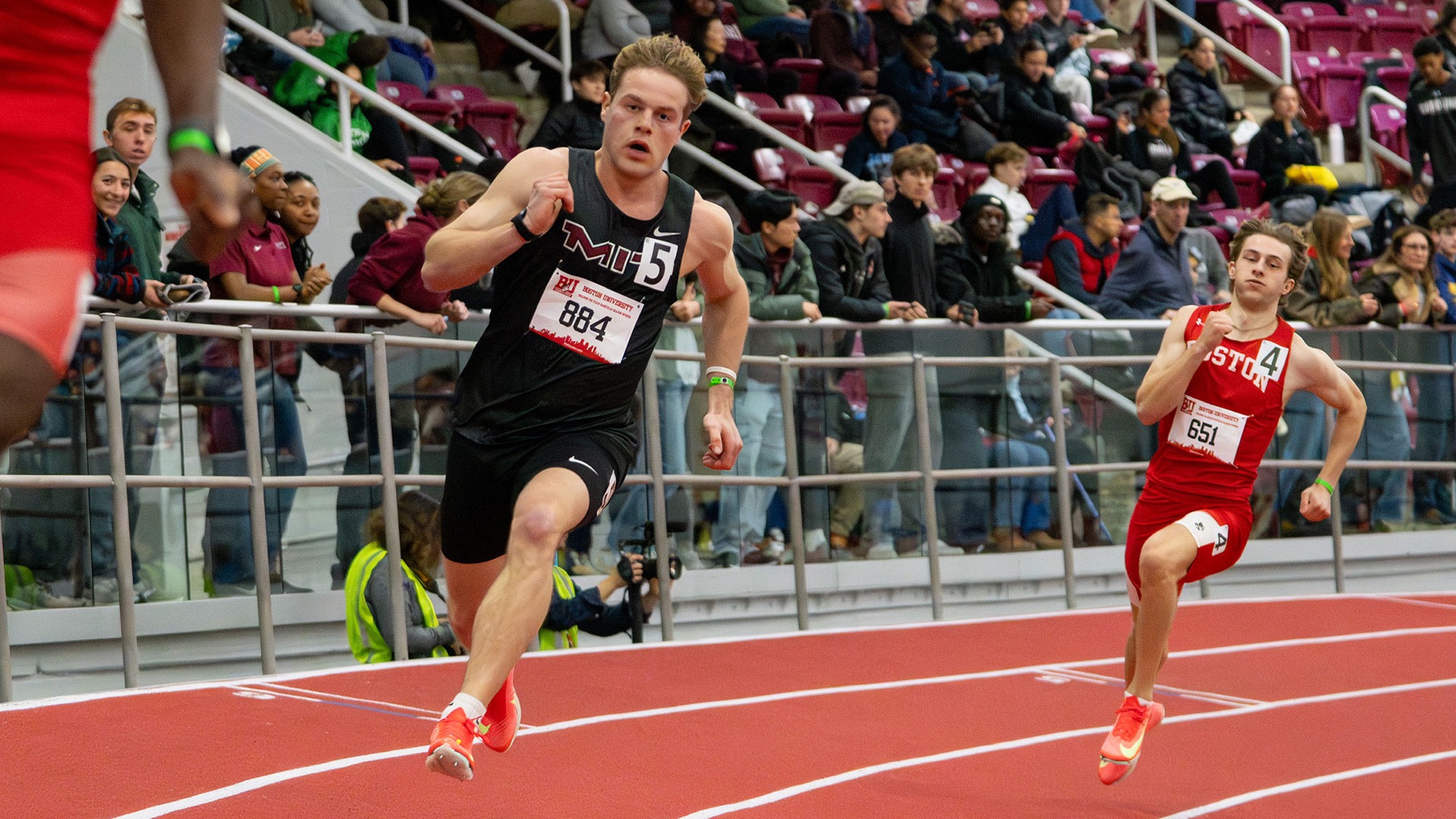 Kristian Praizner runs on a track at BU