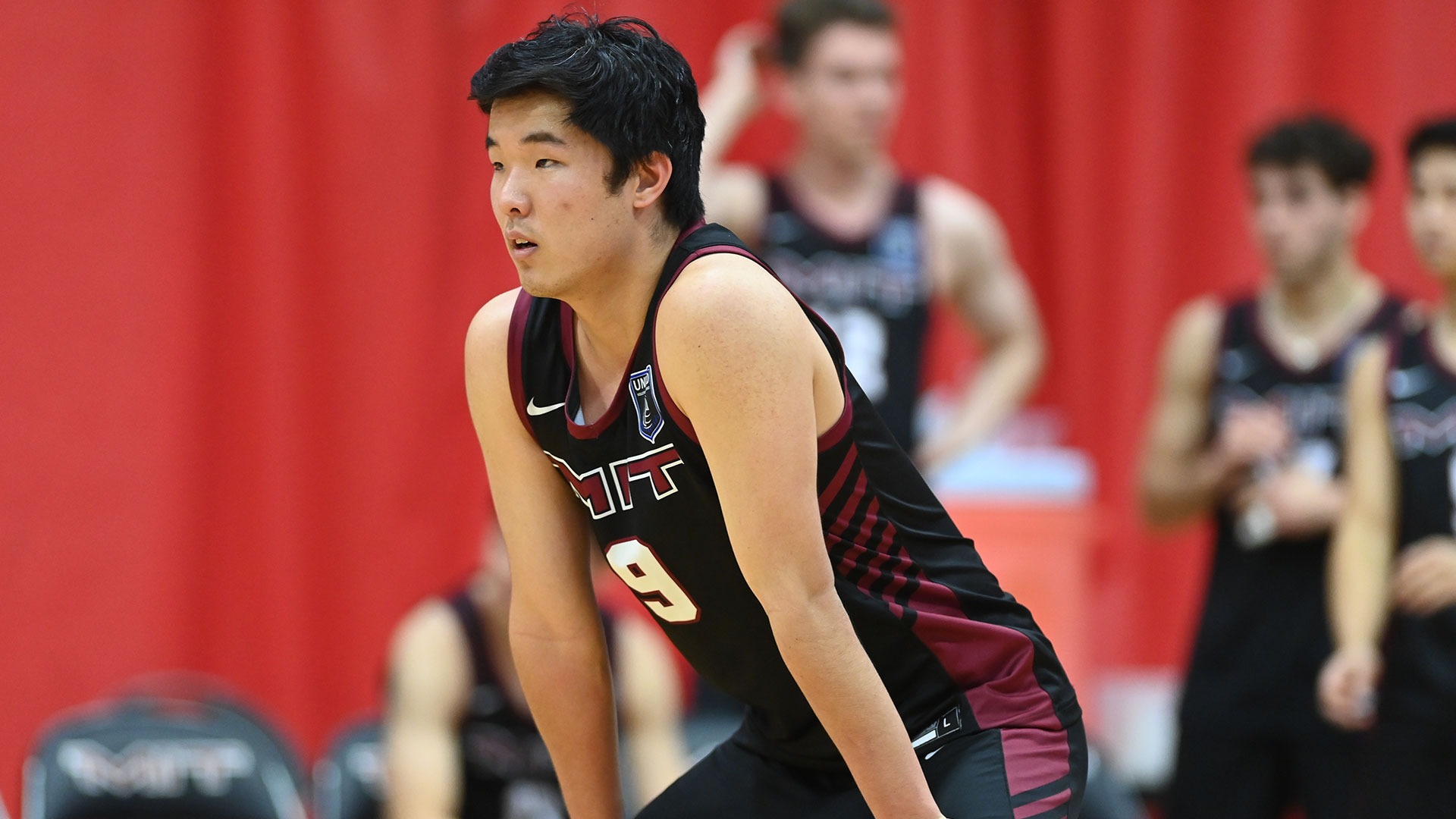 Grant Oh leaning over waiting for a serve