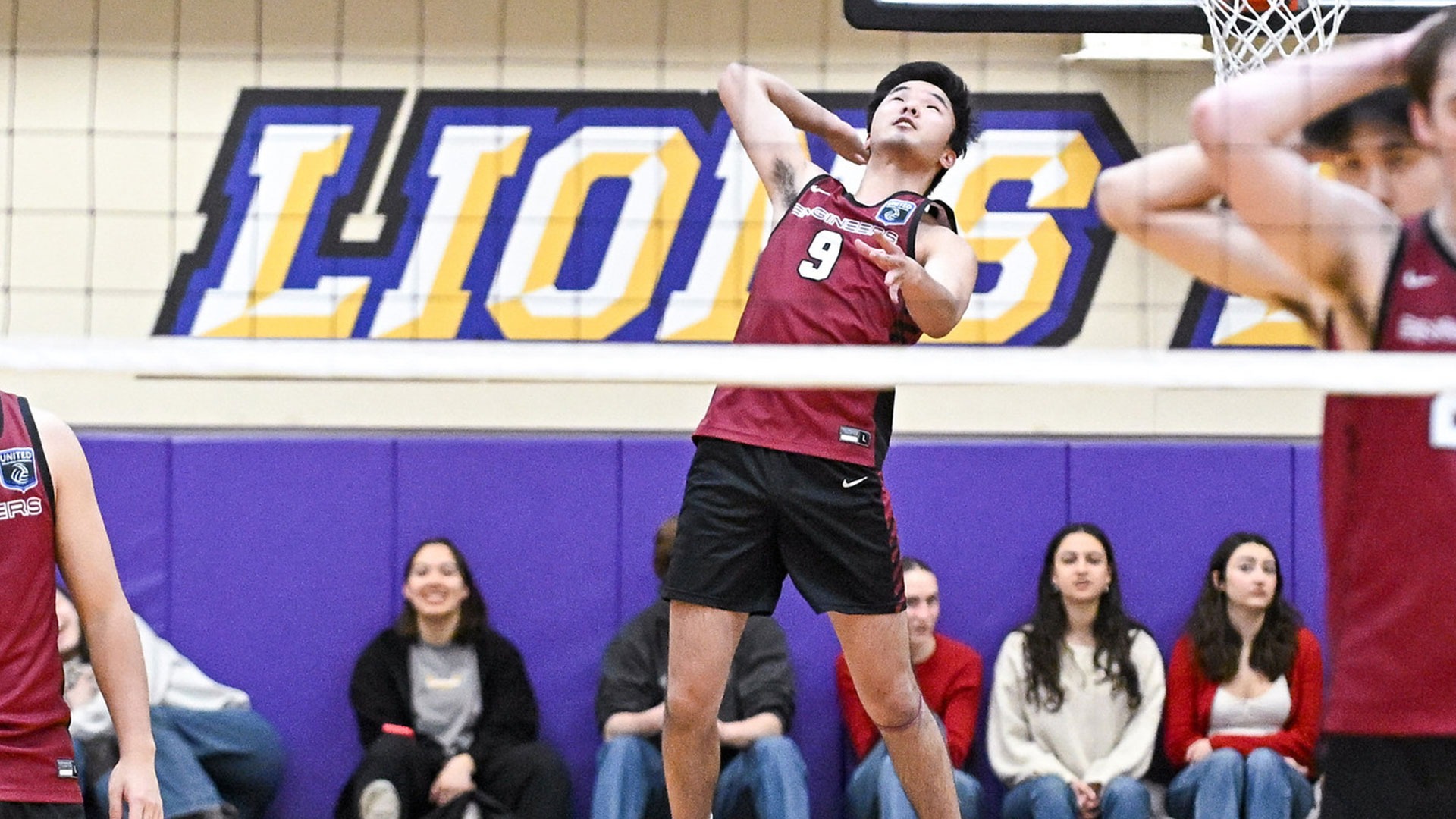 Grant Oh going up for a serve
