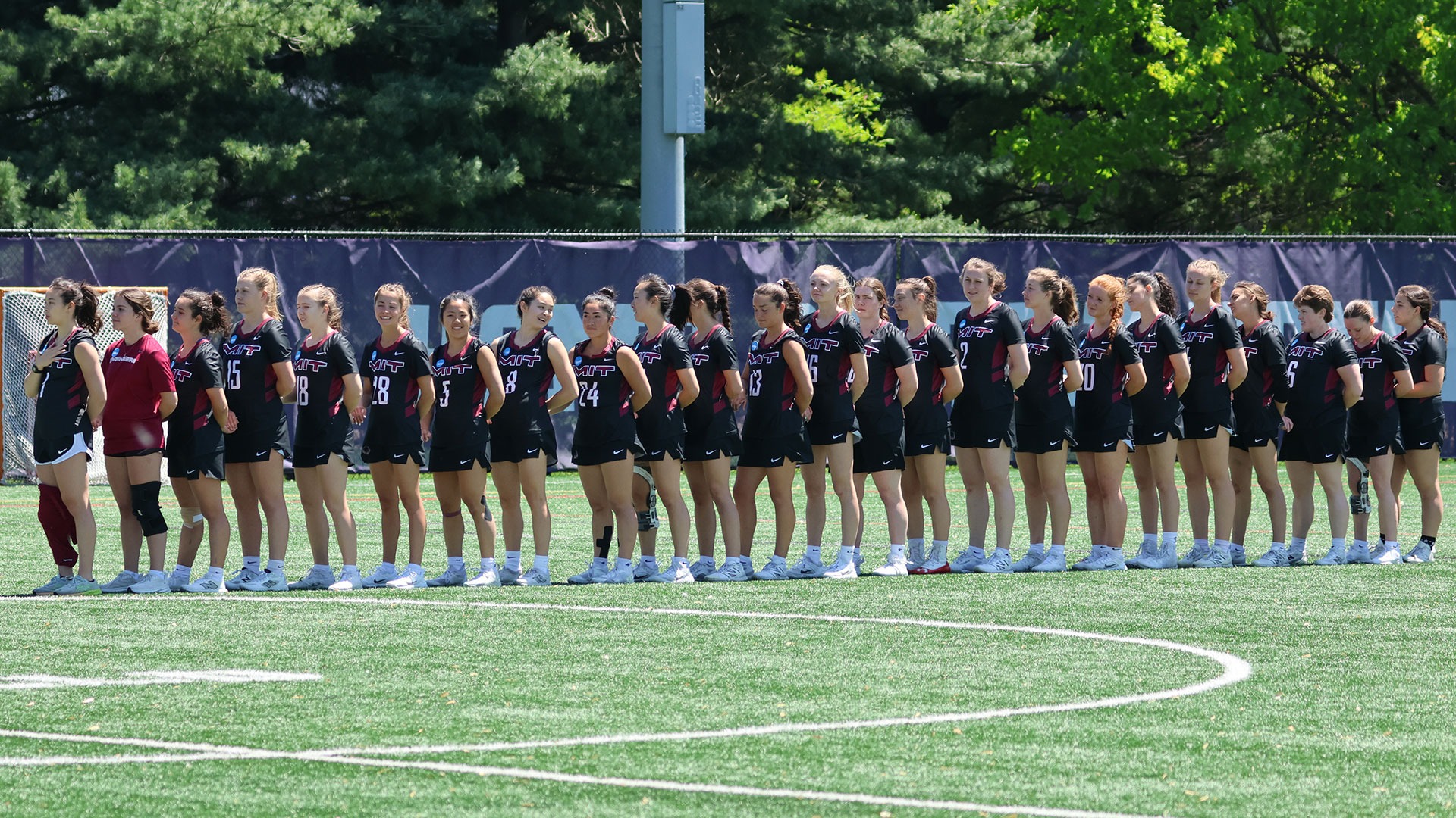 The MIT women's lacrosse team standing in a line