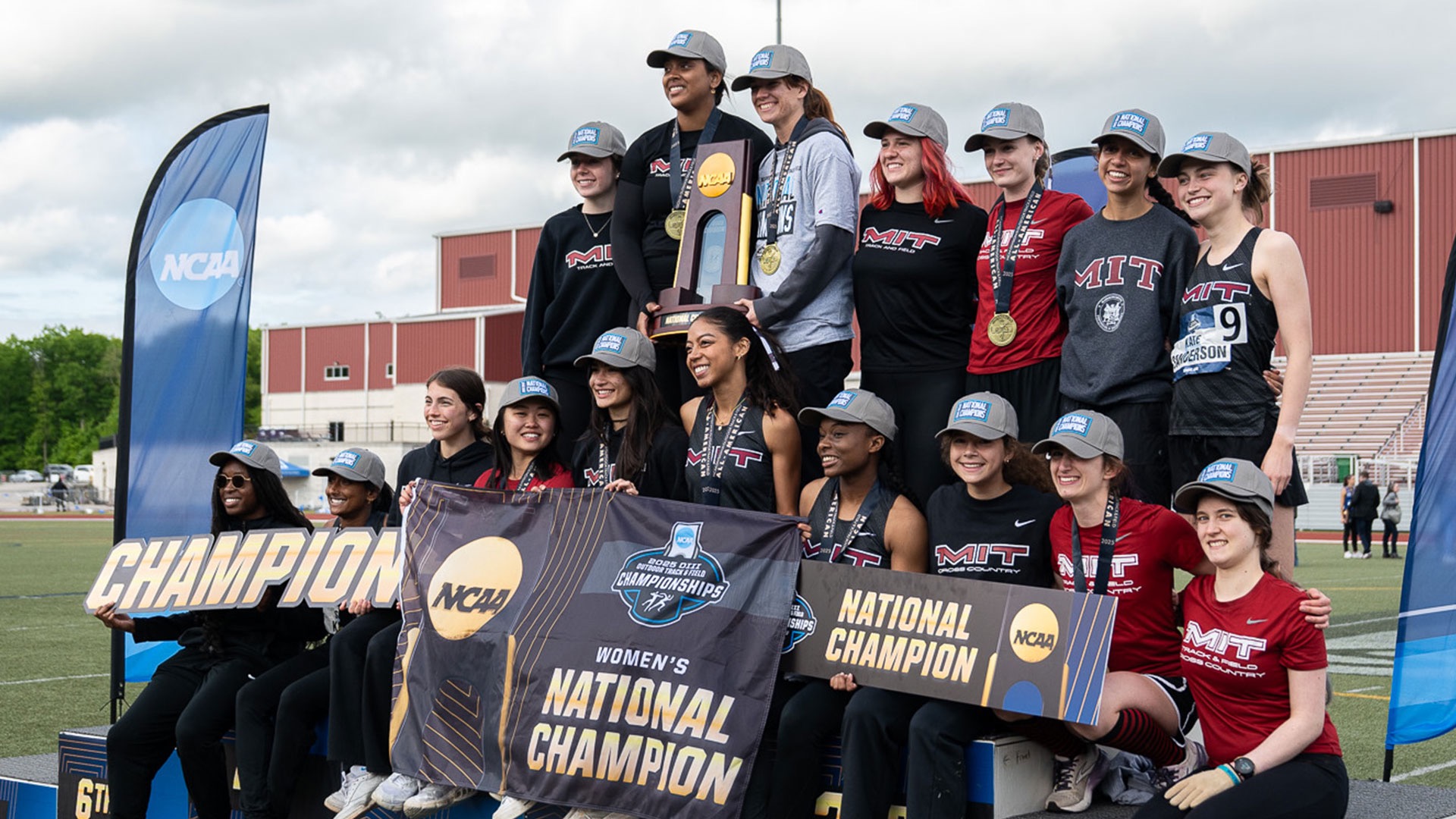 women's track and field with championship trophy