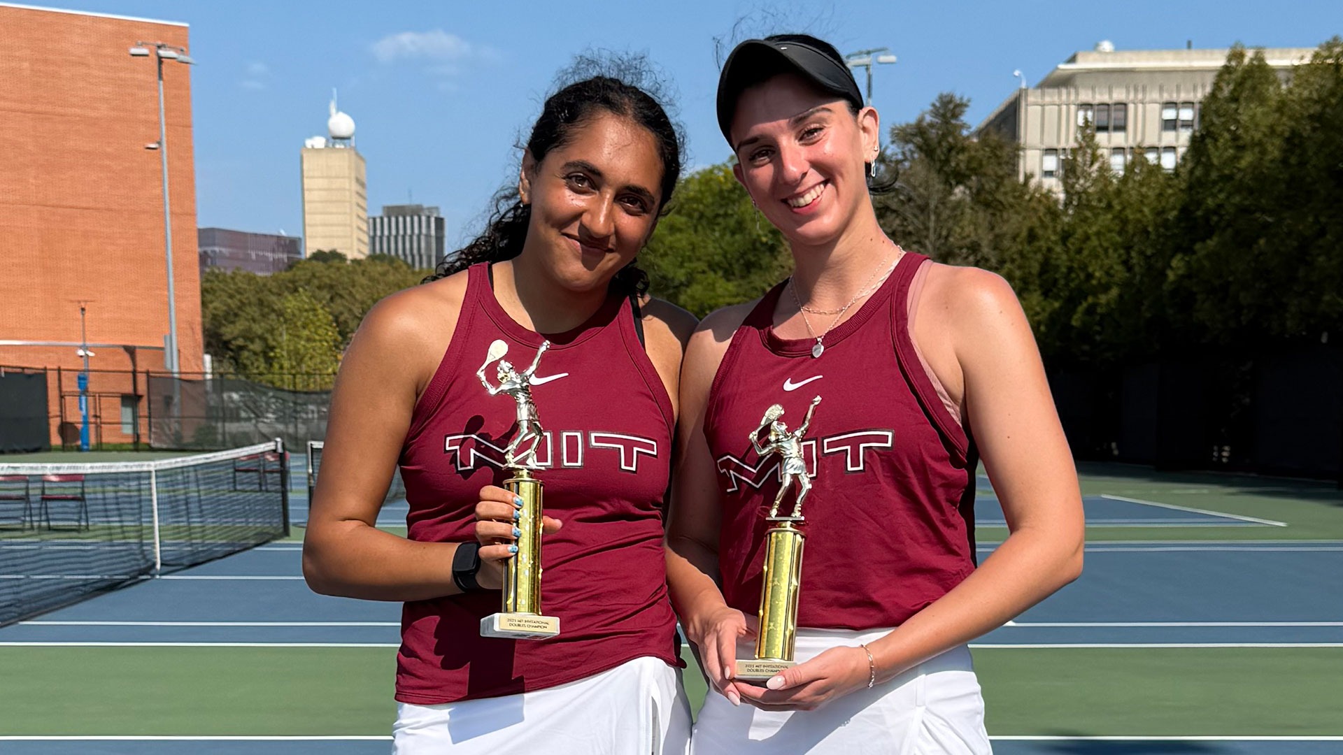 Alaina Kolli and Artemis Pados holding trophies