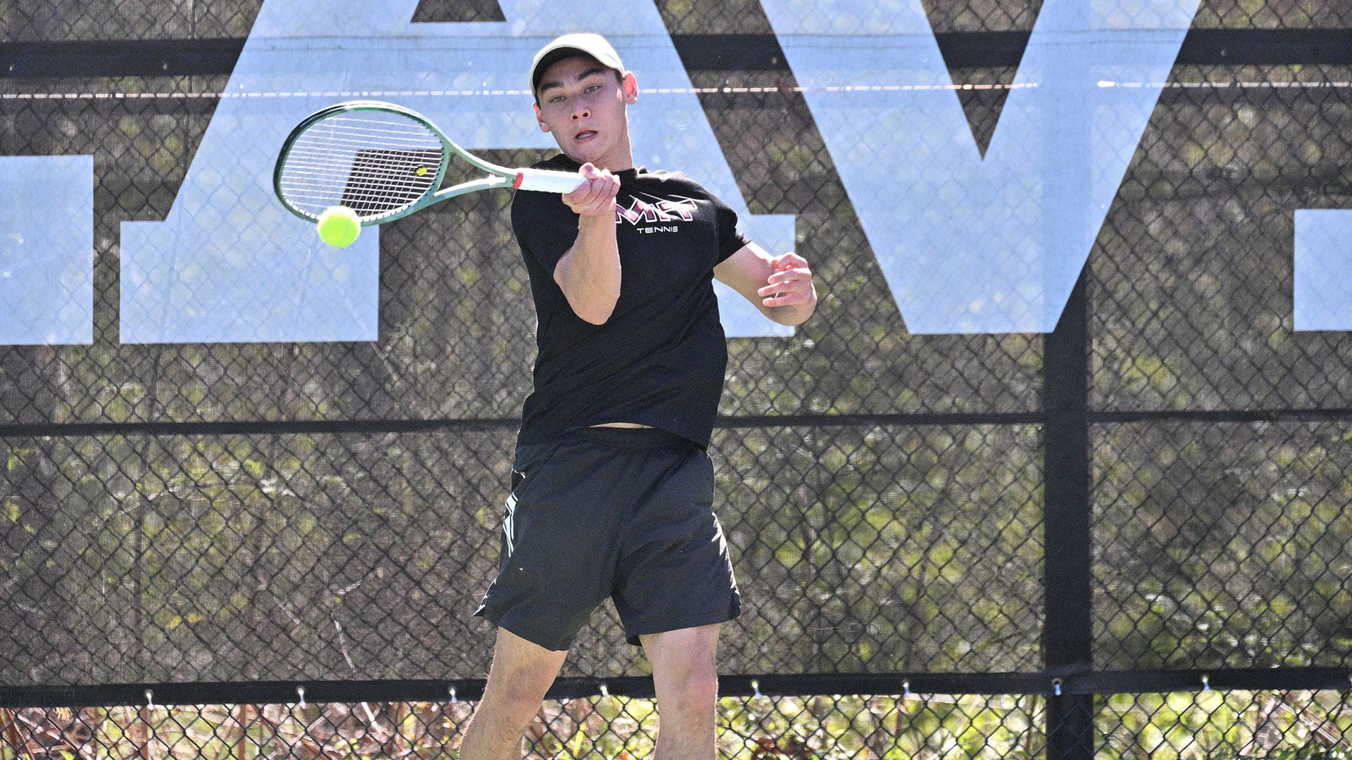 Grant Gallagher hitting a tennis ball