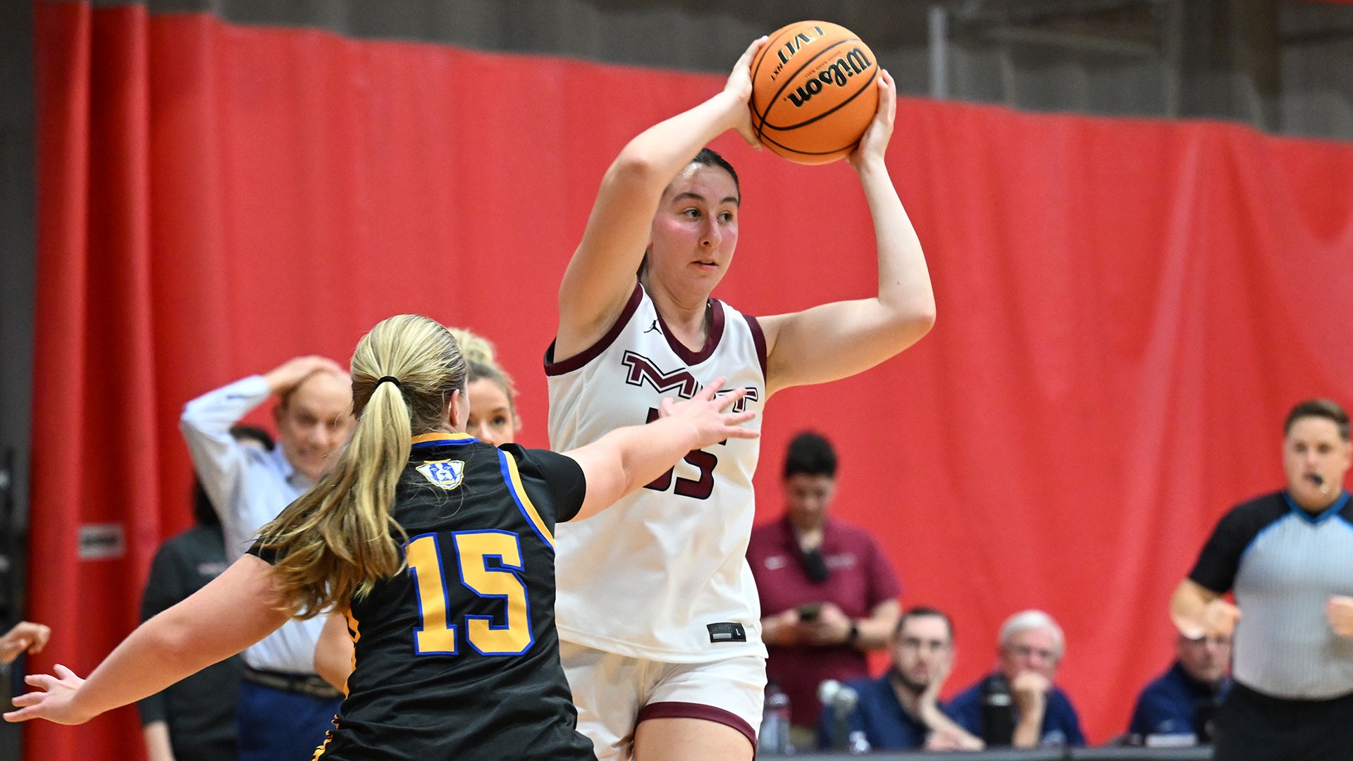 Riley O'Sullivan holding the basketball over her head