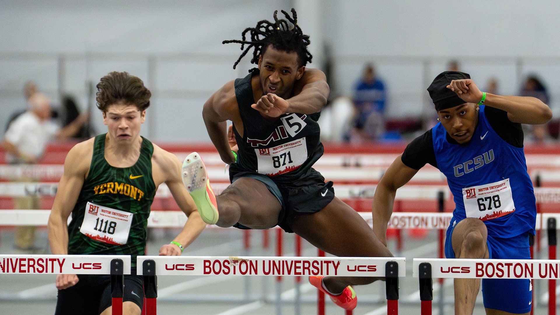 Enoch Ellis runs in the hurdles