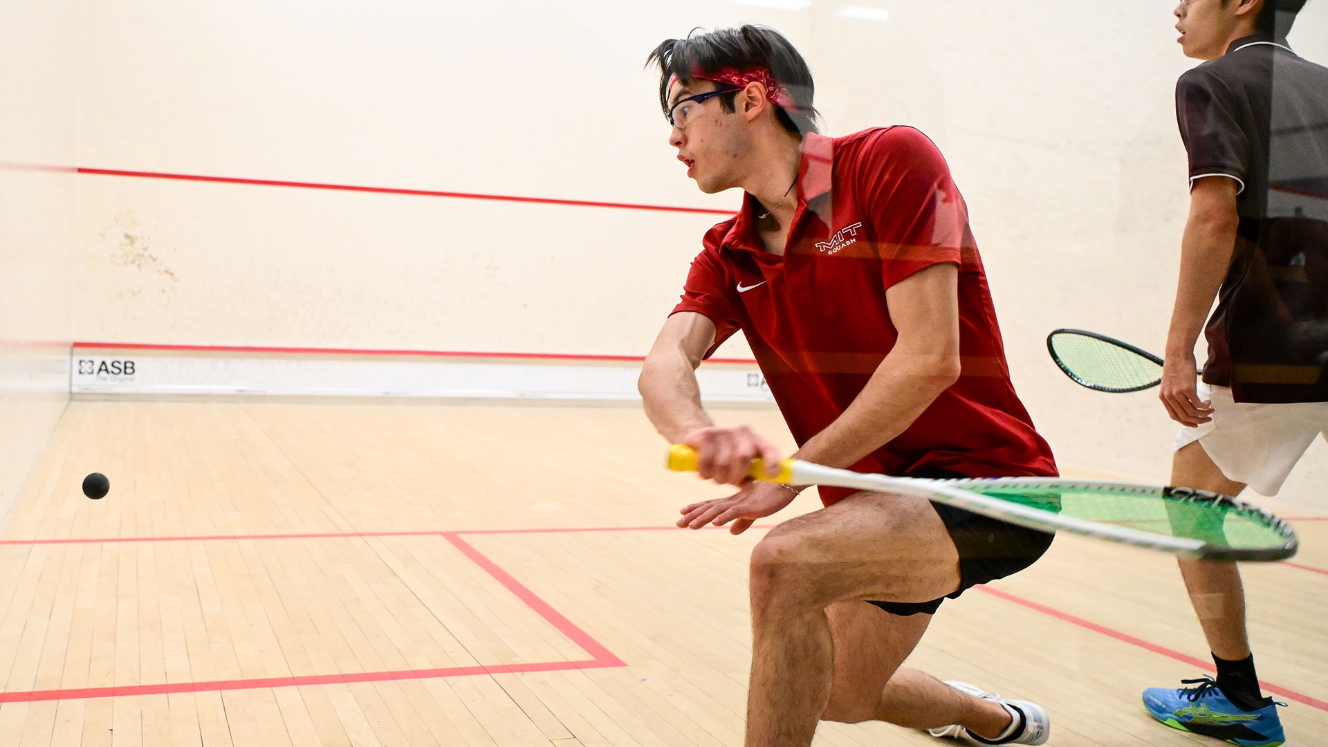 Hyun Su Price hitting a squash ball