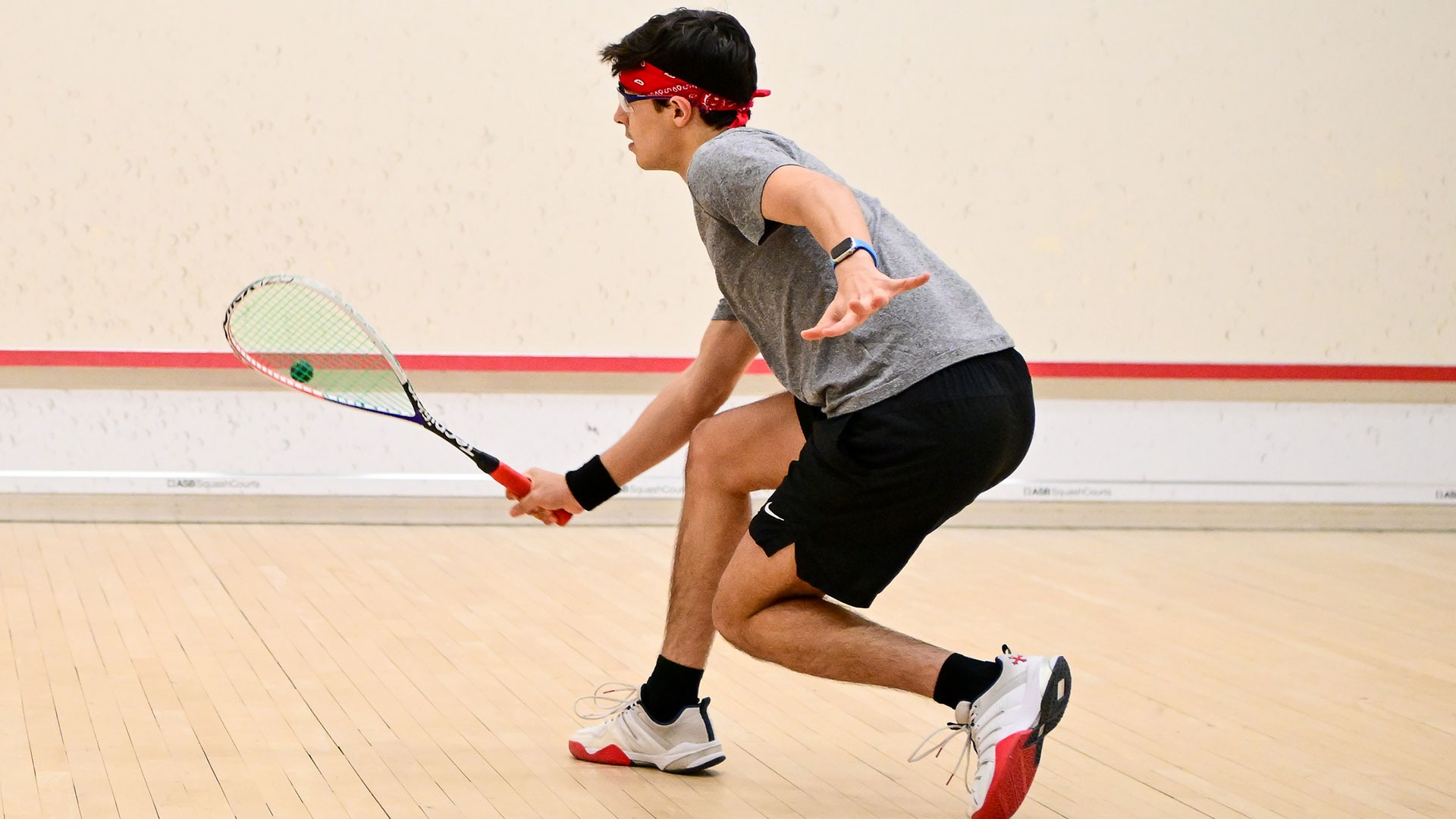 John Gunton hitting a squash ball