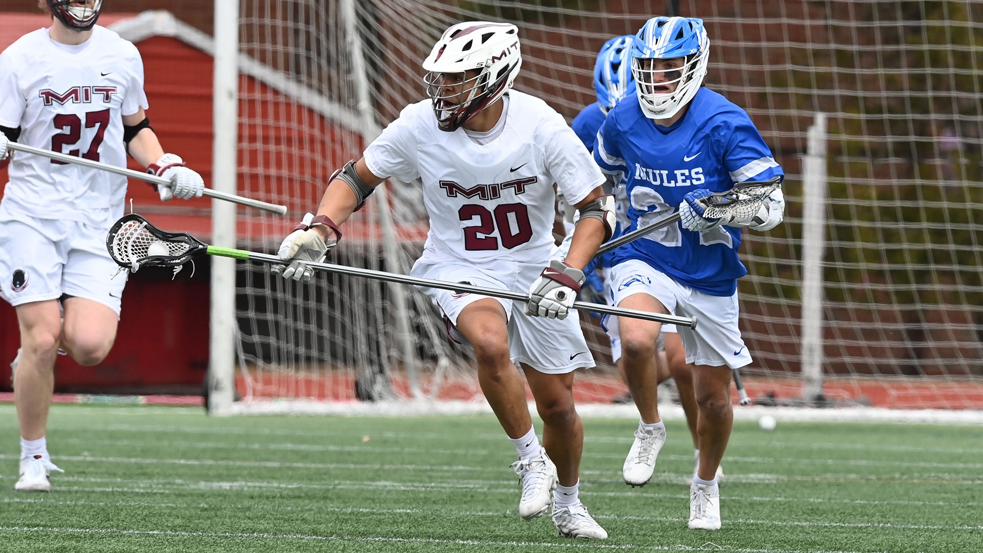 Isaiah Nathaniel running on the field with a ball in his lacrosse stick