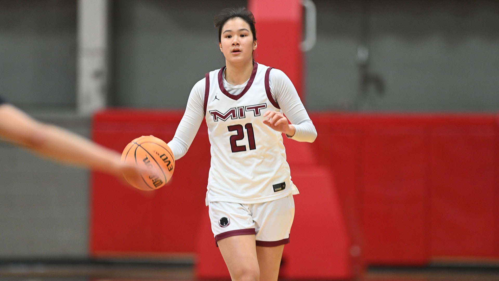 April Chan dribbling the basketball down the court