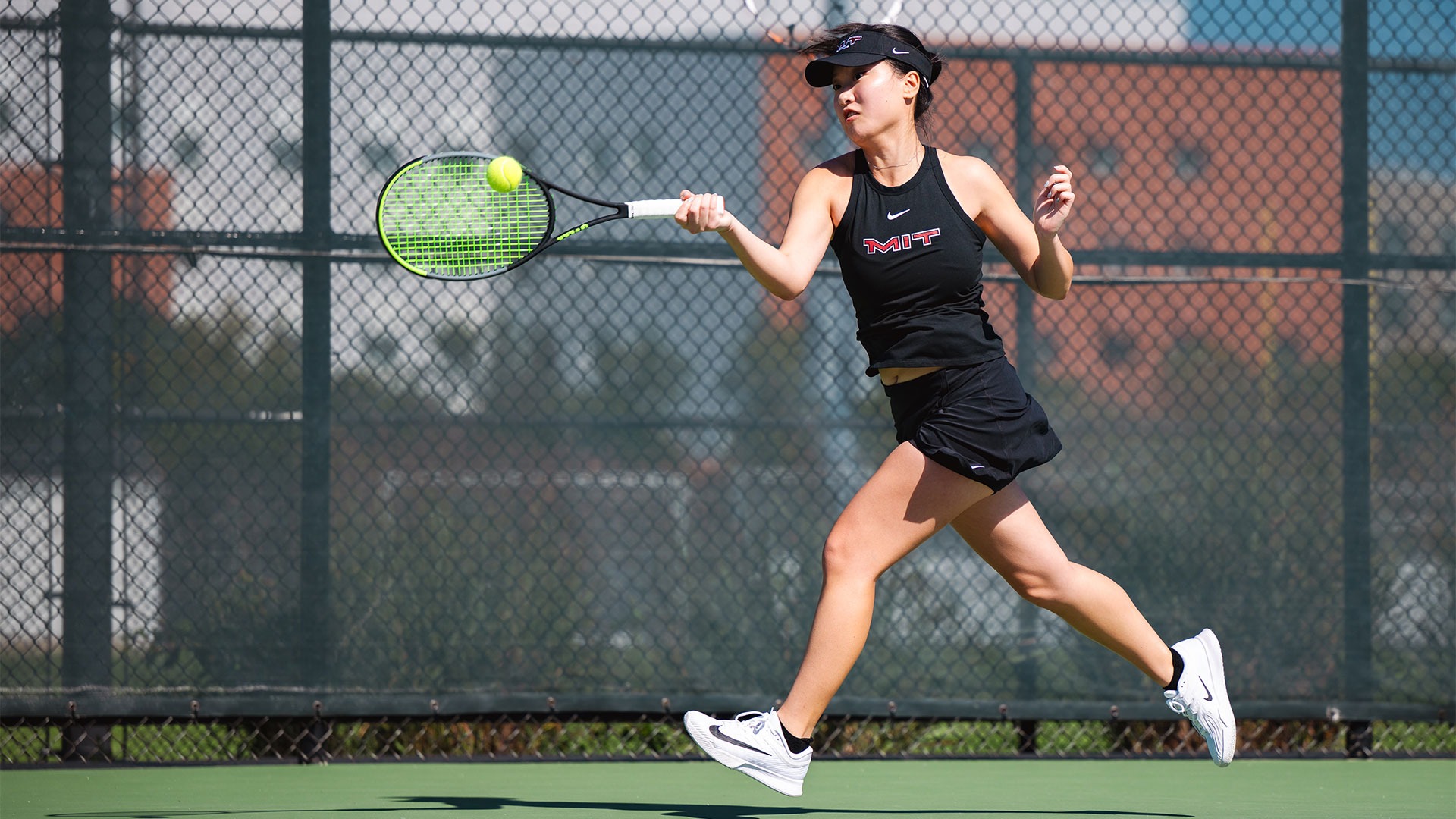 Alicen Liu hitting a tennis ball with her racket