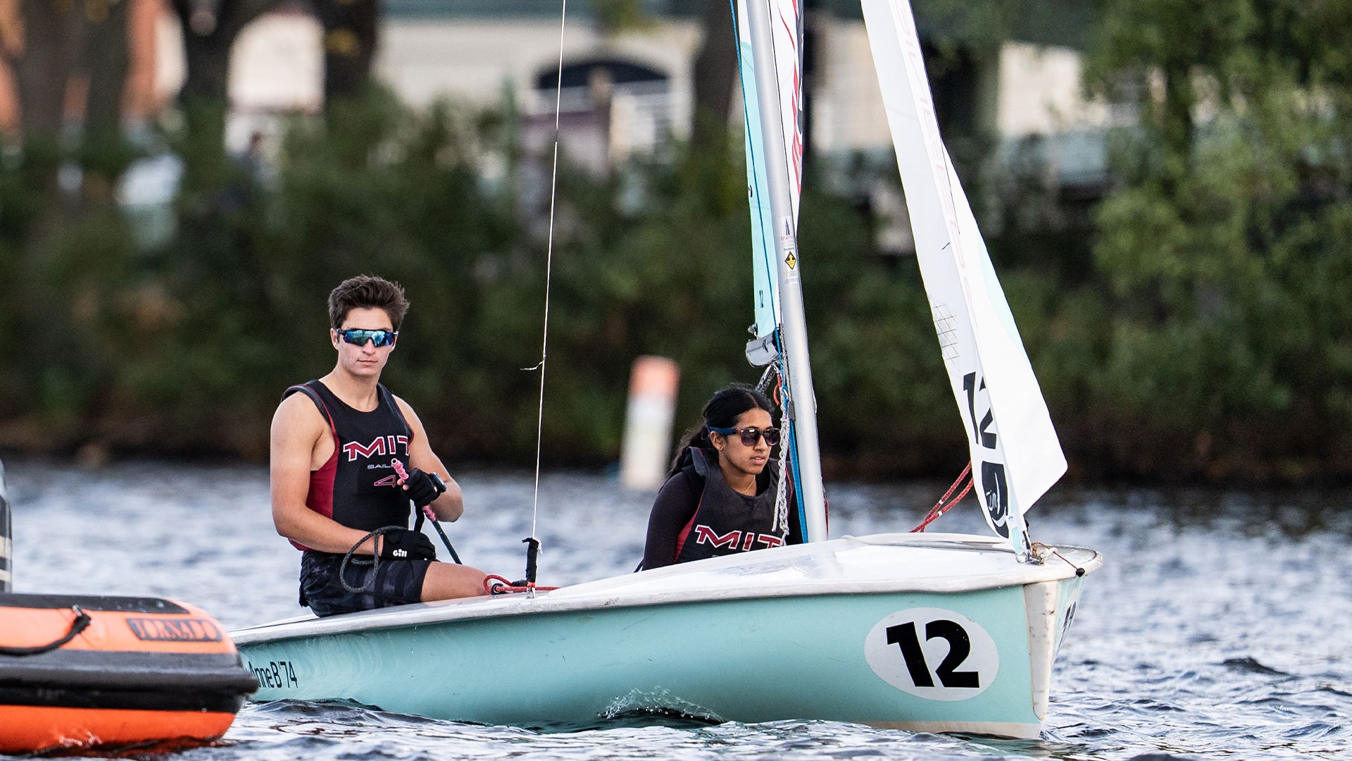 Robert Ulmer and Ellie Pinot on a sailboat on the Charles