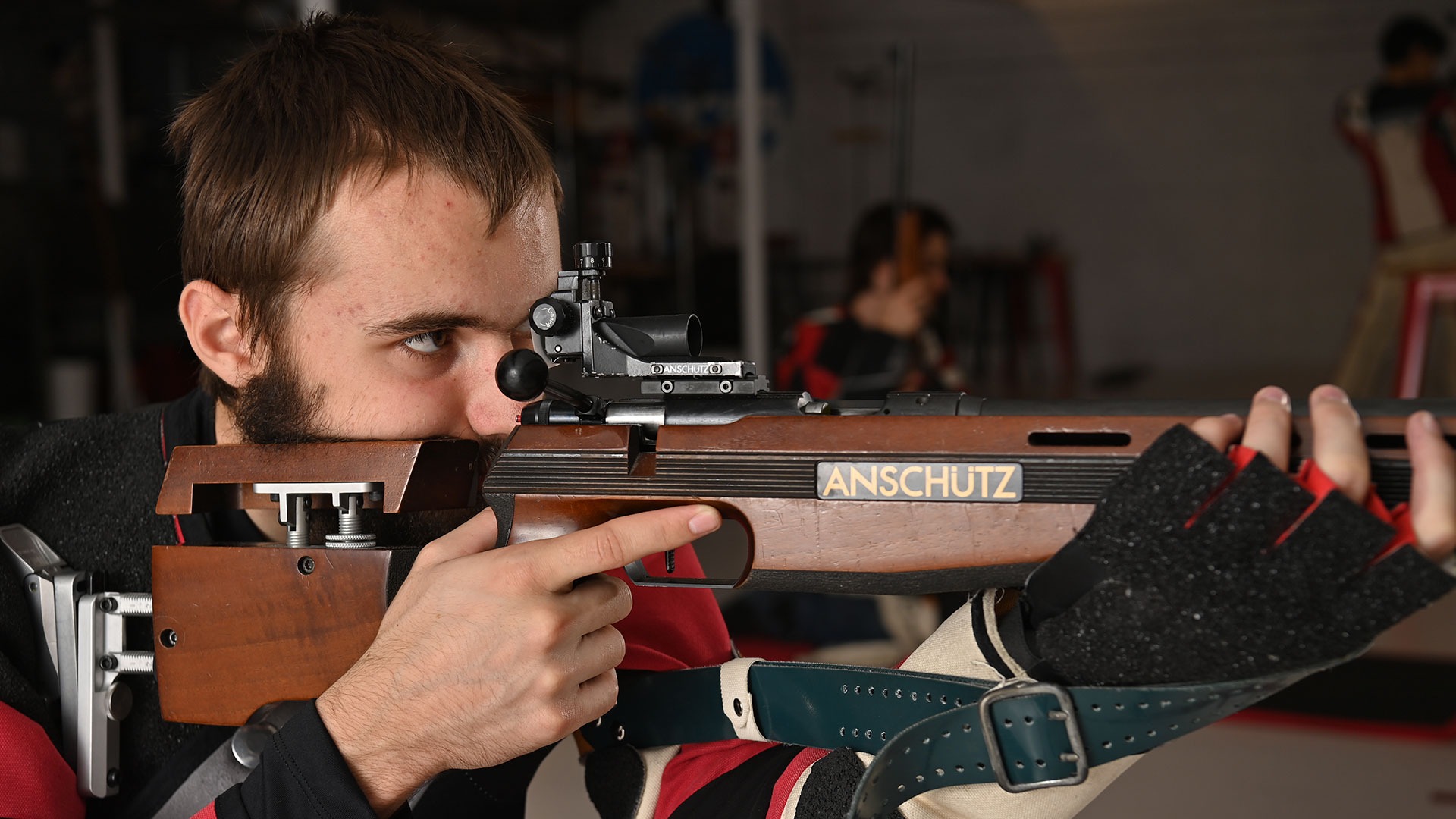 William Knowlton aiming his rifle down range