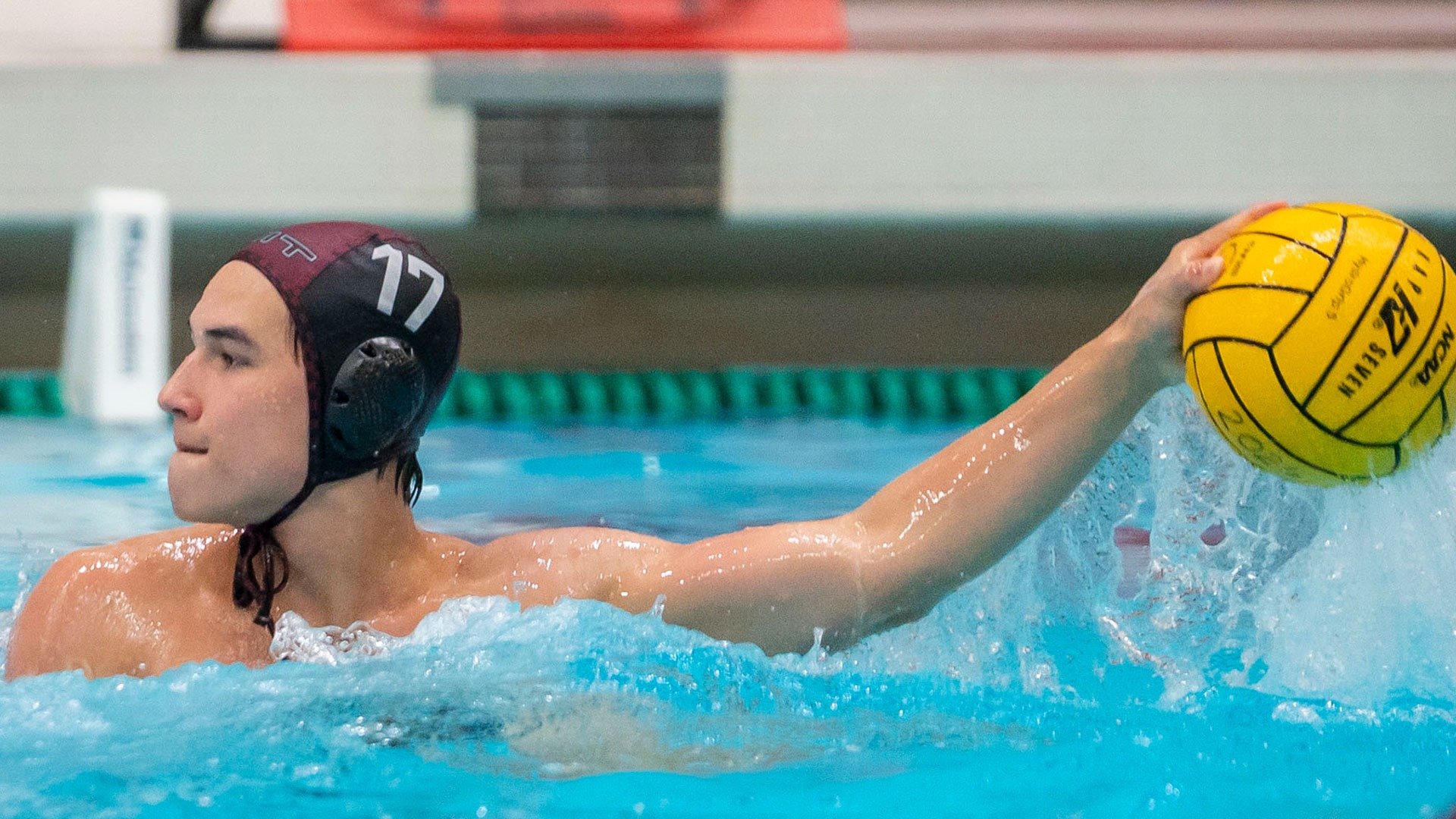 Derek Schaffer holding up a water polo ball