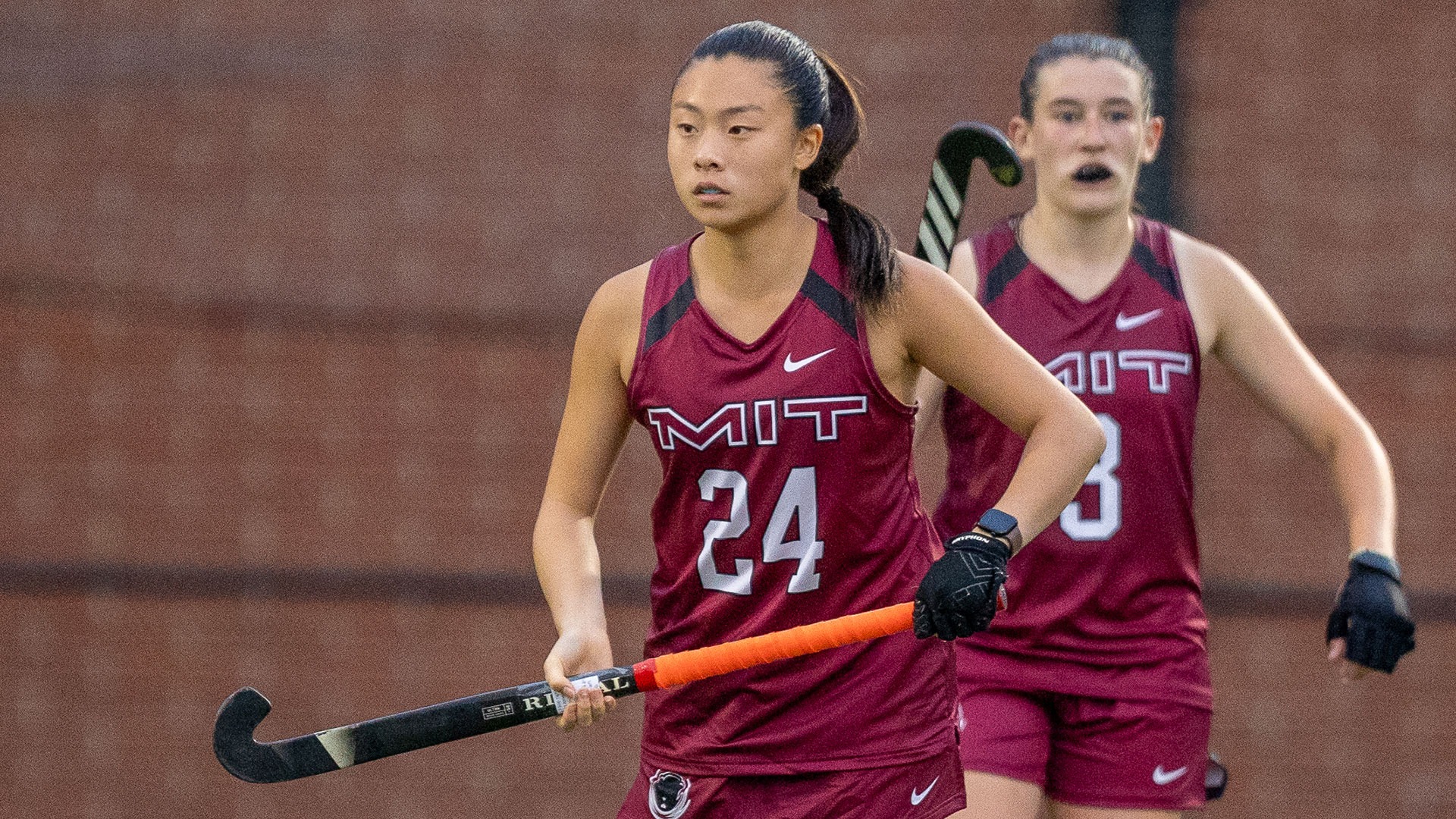 Charlotte Lee standing and holding her field hockey stick