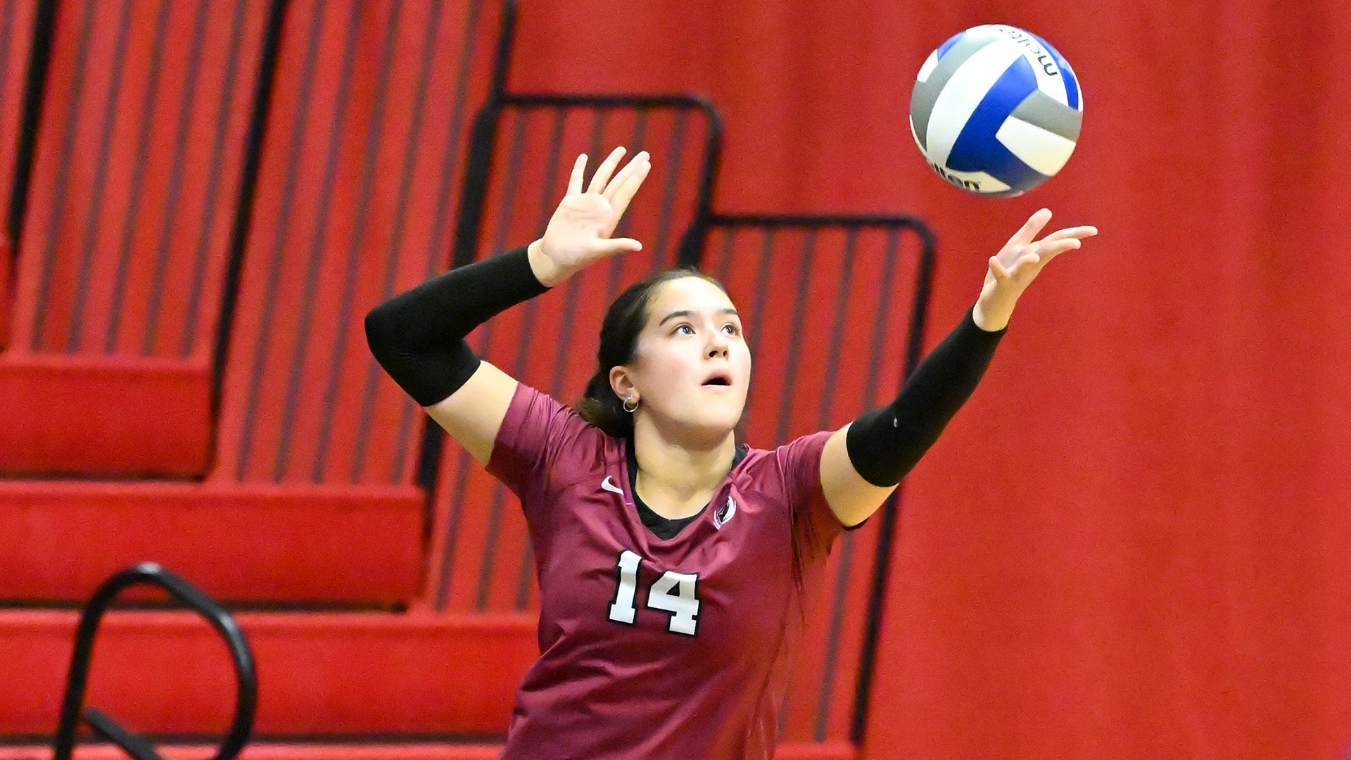 Maya Licznerski serving the volleyball