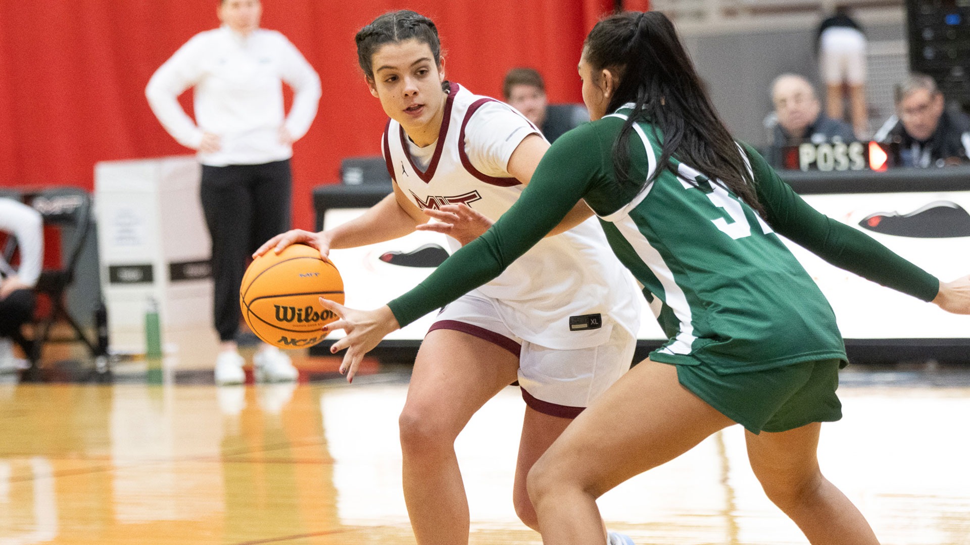 Mary Lobon dribbling the basketball while being defended