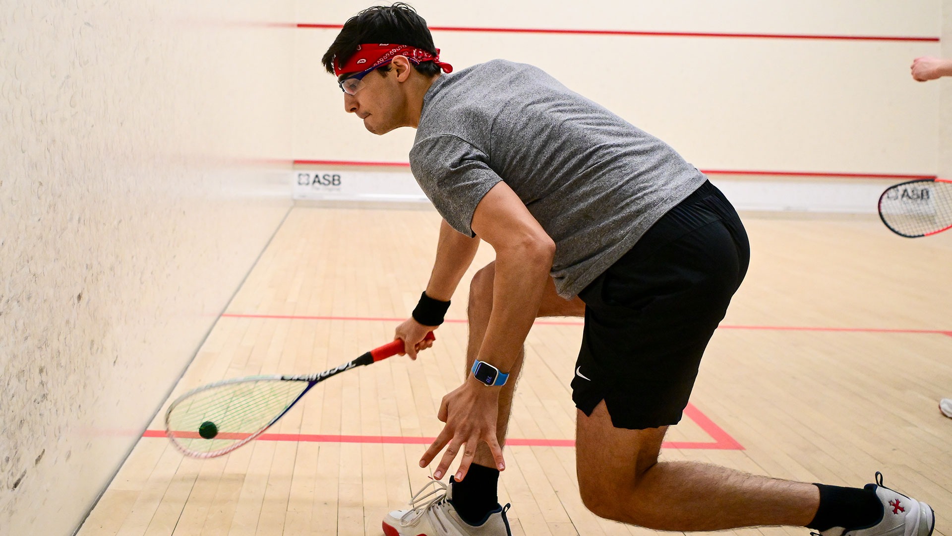 John Gunton hitting a squash ball