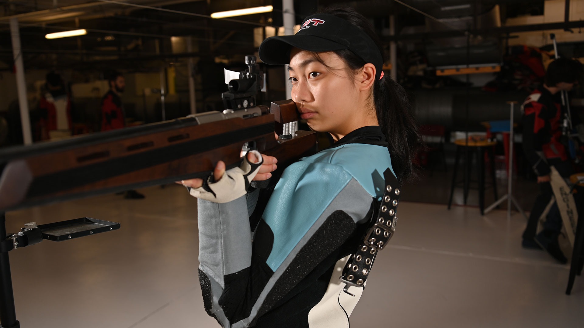 Eleanor Yang aiming her rifle down range