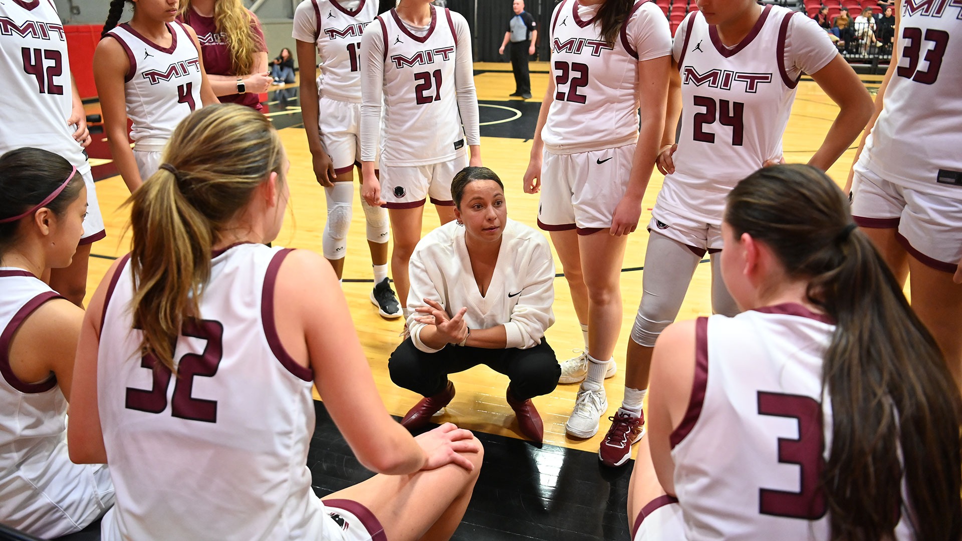 The women's basketball team in a huddle