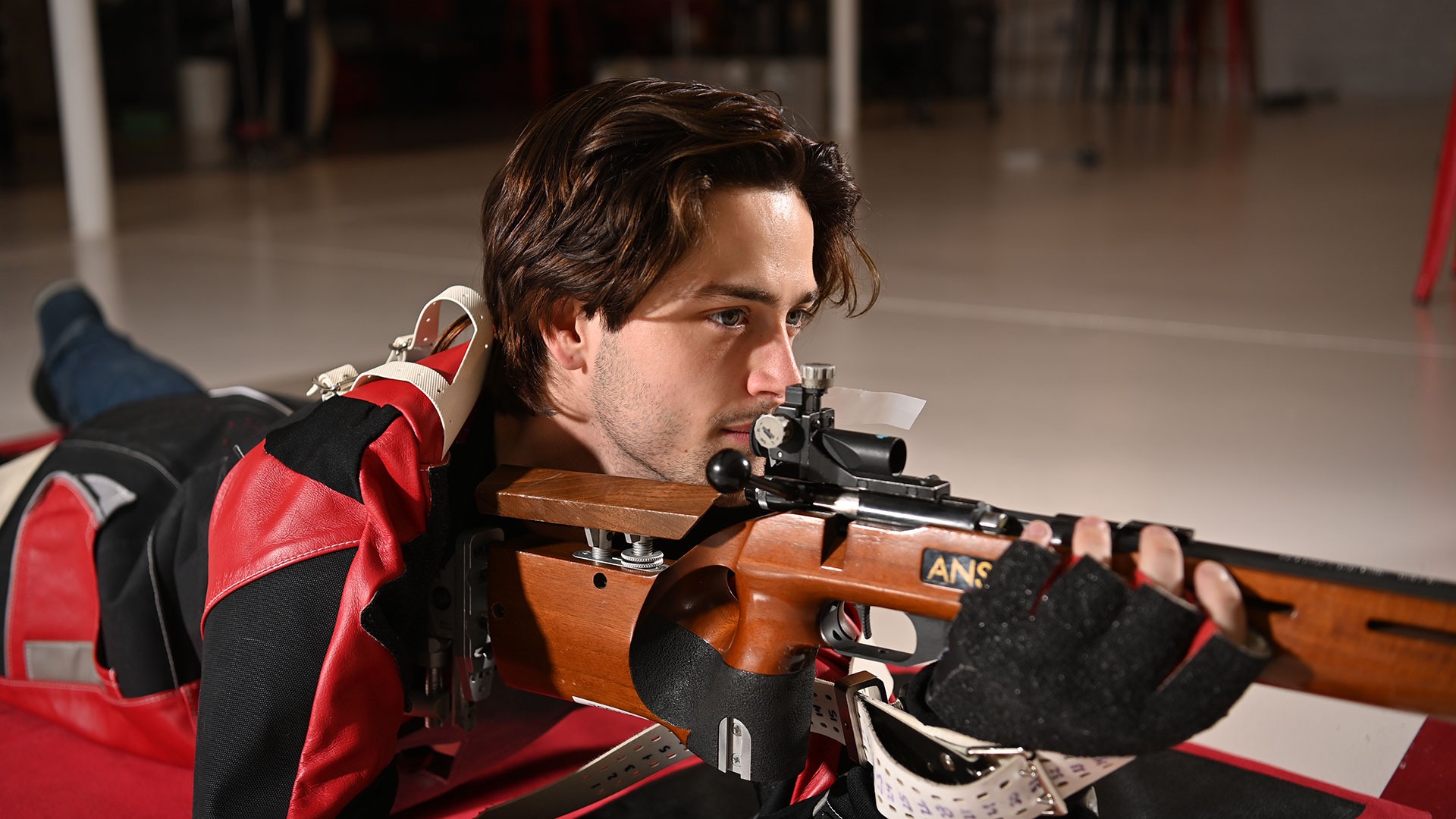 Spruce Campbell aiming his rifle down range
