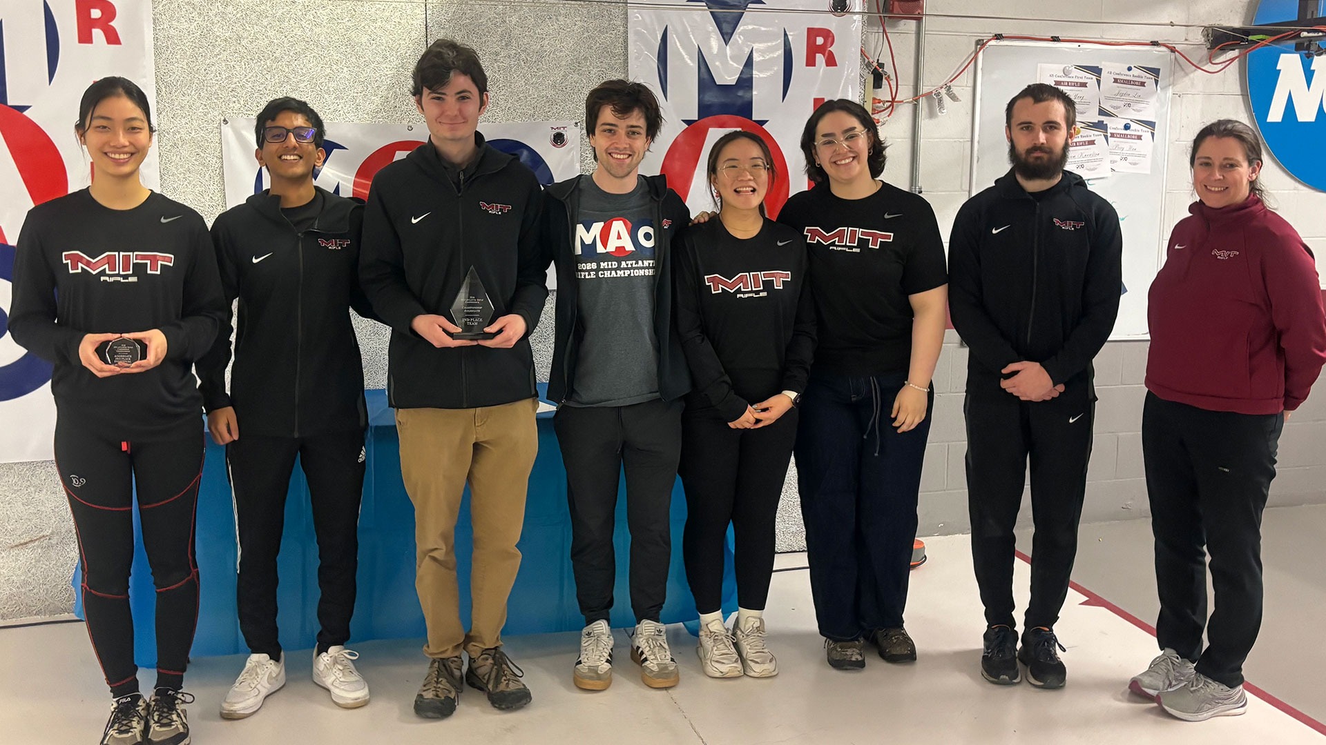 The MIT rifle team holding awards after the MAC Championship