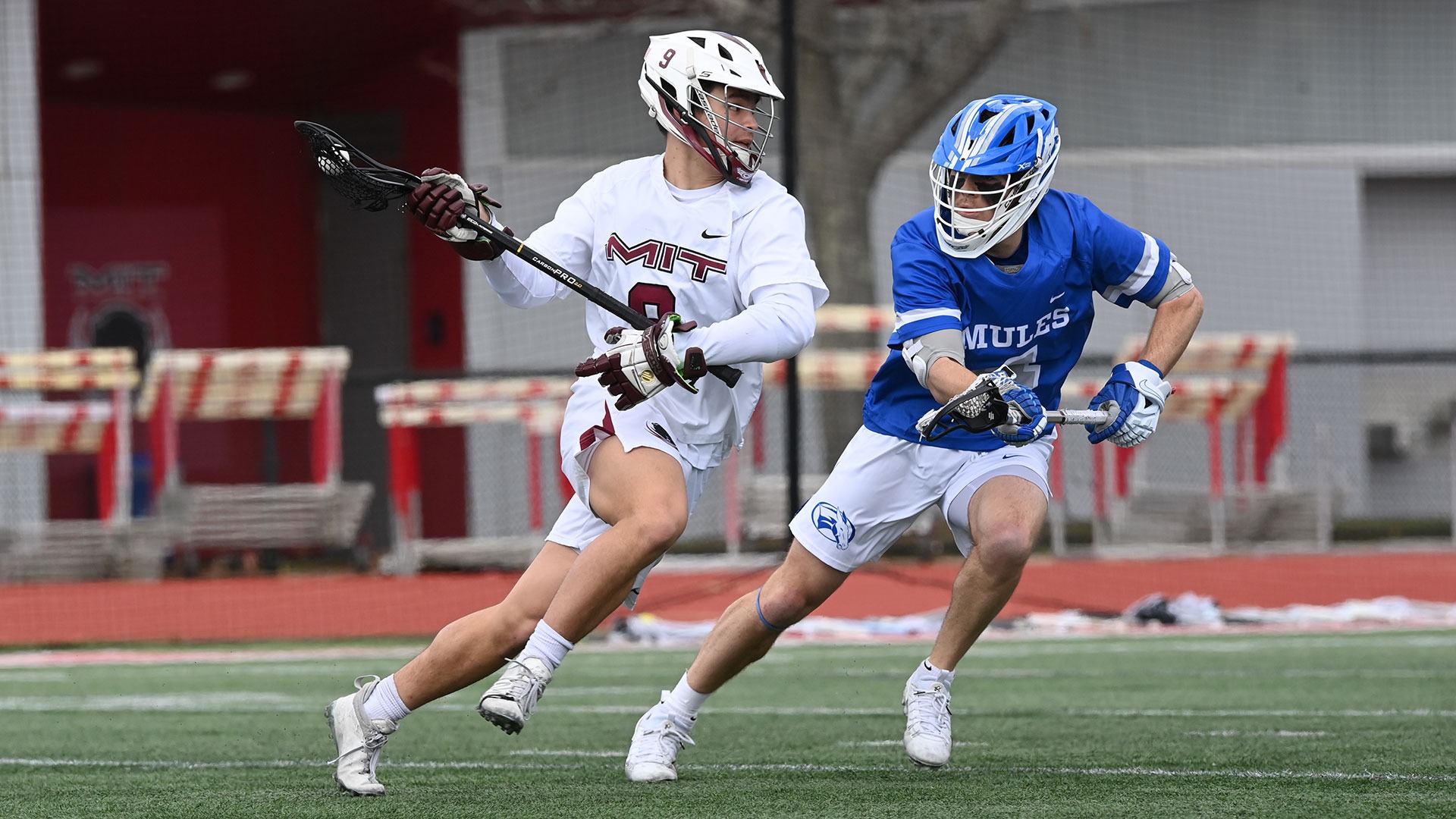 Hayden Calabretta running past a defender with the ball in his lacrosse stick