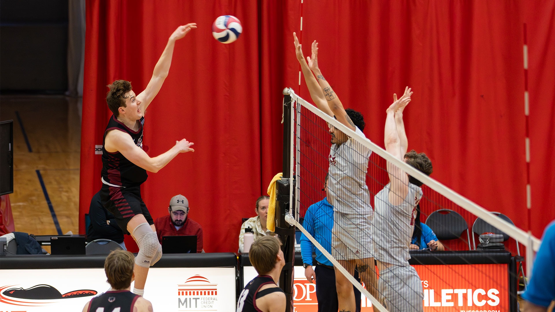 Henry Garewal going up to hit a volleyball